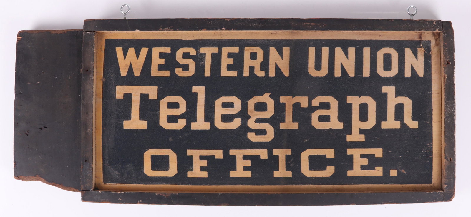 An Early Wooden Western Union Sign: A wooden sign with a blue ground and white lettering that reads at both sides "Western Union Telegraph Office". With original paper tag as pictured. Dimensions: 37 1/2" x 15". Provenance: From a local