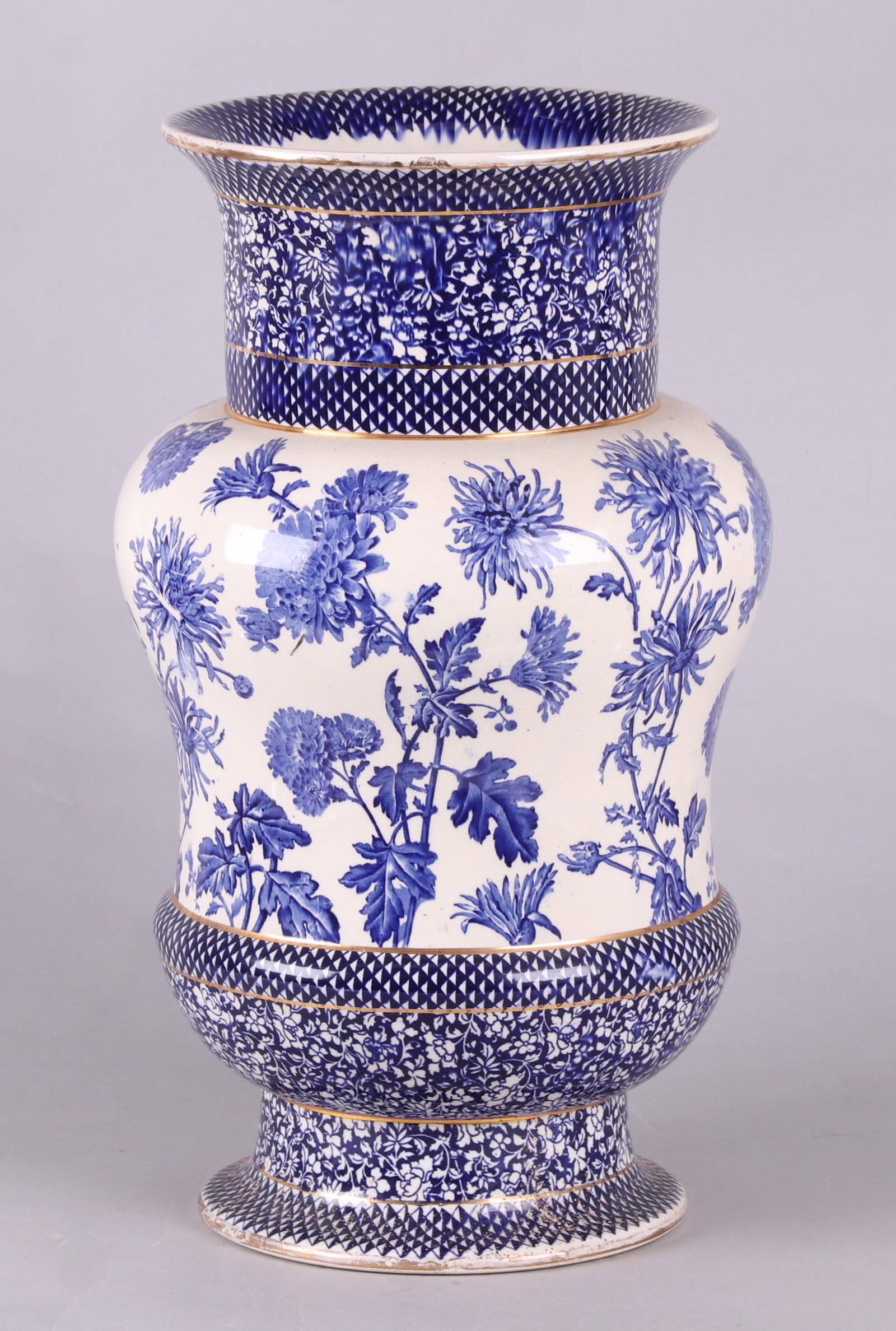 Royal Doulton Pottery Umbrella Stand: A late 19th century pottery umbrella stand with blue floral transfer decoration and gilt piping. Dimensions: 13" in diameter, 23" tall. Provenance: From a local estate.
