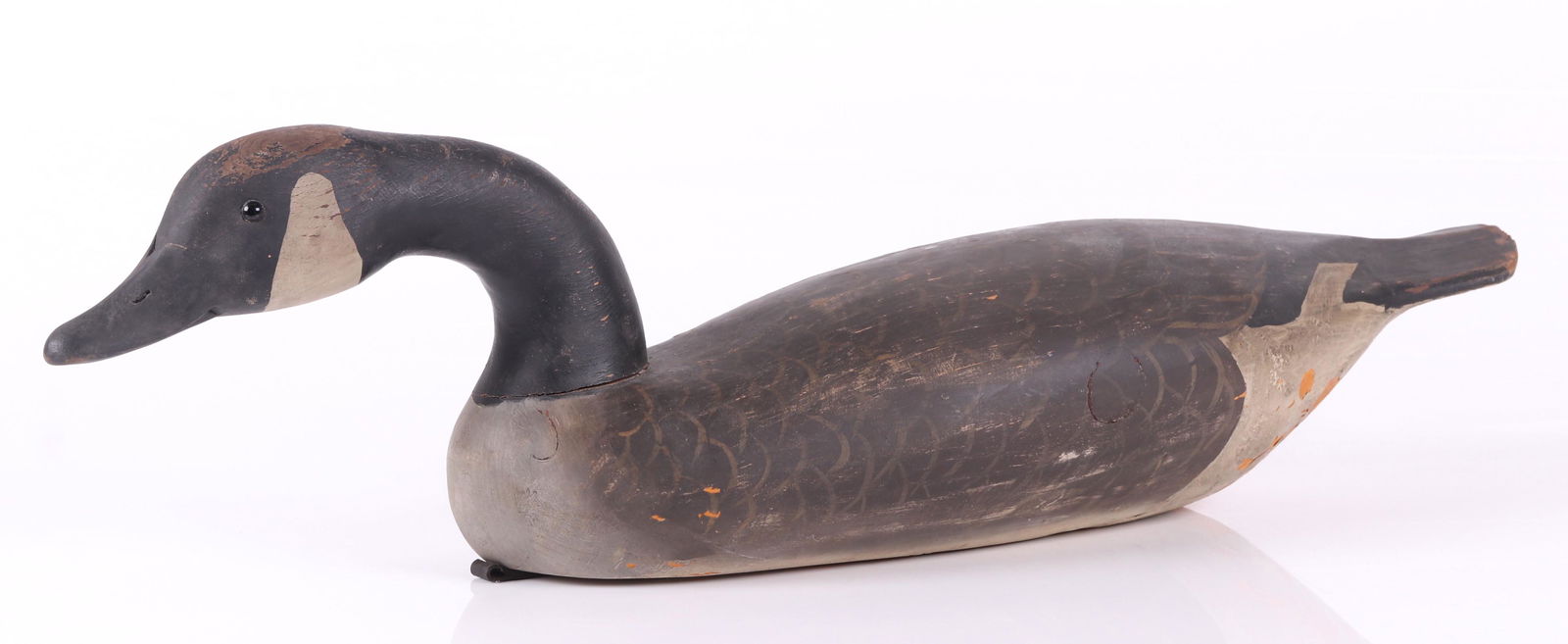 Canada Goose Decoy by Bob Biddle: A life sized decoy with a painted surface and glass eyes. Signed as pictured. Dimensions: 28 1/2" x 9 1/2", 8" tall. Provenance: From a Main Line collection.