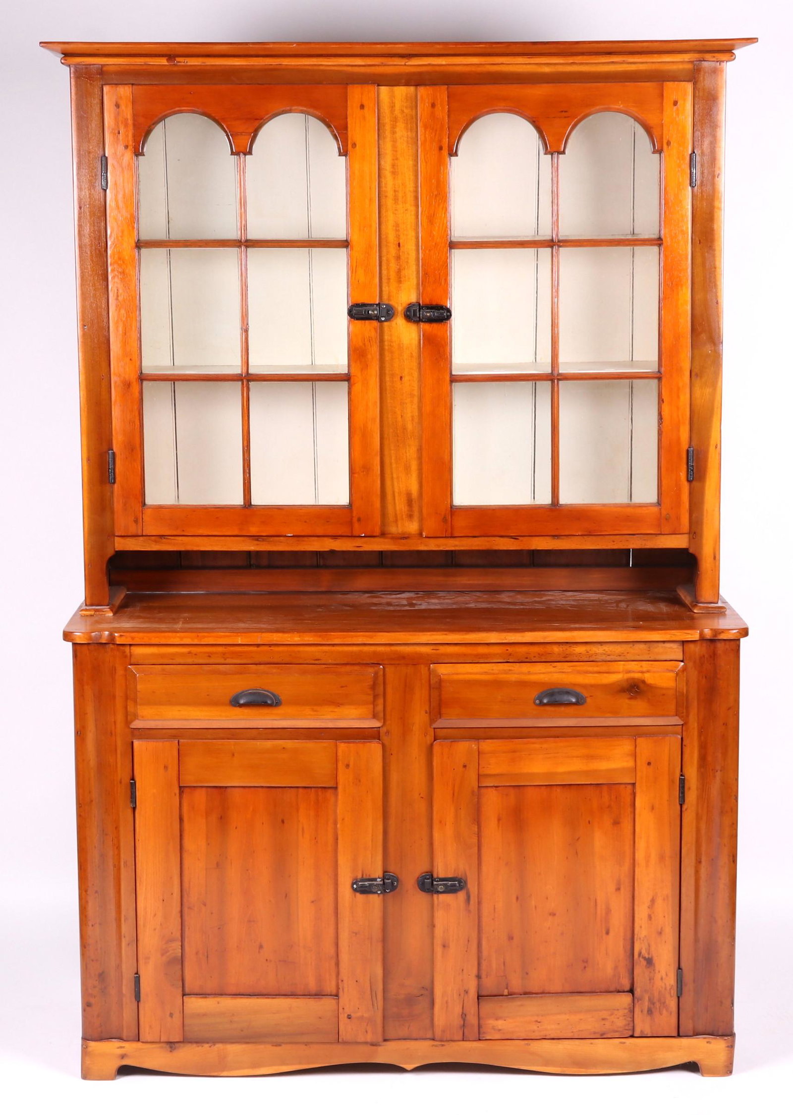 19th Century Poplar Stepback Cupboard: With a cut bracket foot and scalloped base, below two paneled doors and two short drawers; the upper case features two glazed doors with a total of twelve lights, all below the molded cornice. Dimensi