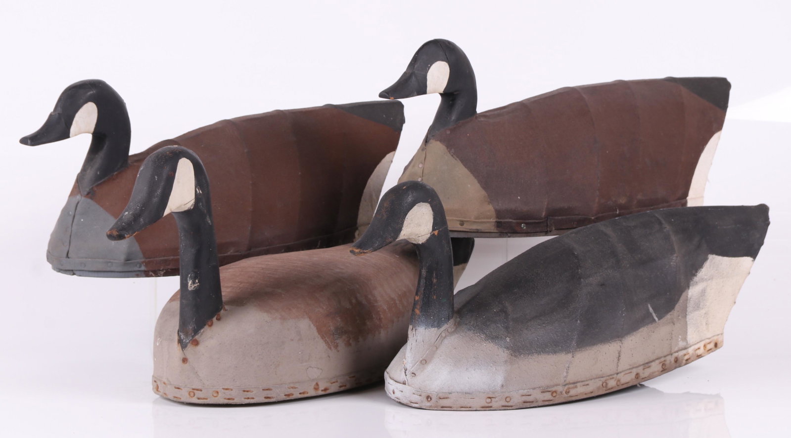 Four Canvas Canada Goose Decoys: Mid 20th century. Wooden bases and heads, canvas covered wire bodies, all hand painted, one inscribed "Made by Harry Demoll, HdG., Md. (Havre de Grace, Maryland), c. 1960. Dimensions: From 23 1/2" to 