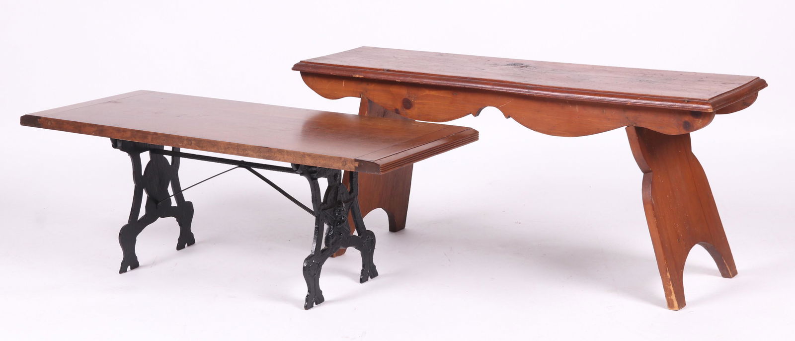 Two Wooden Benches: Both 20th century. One is pine with canted supports, scalloped frieze, and a molded seat. The other has a mahogany top and cast iron supports, with are decorated with a bust of Washington in profile a