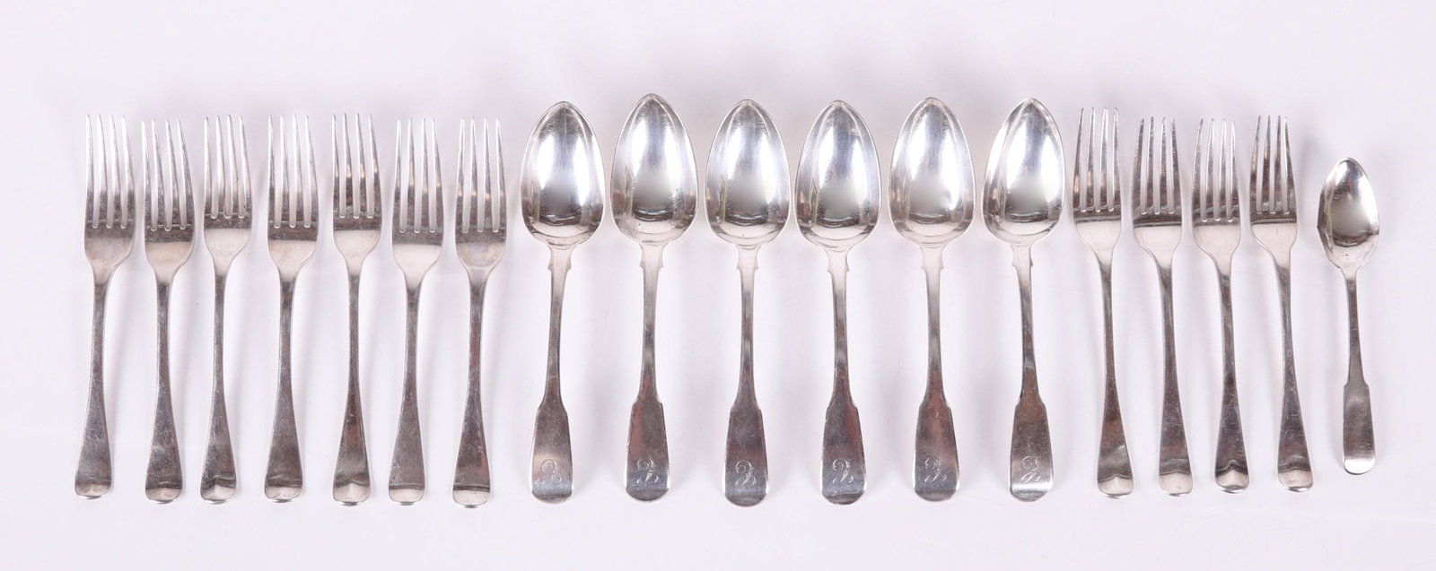A Group of George III Sterling Flatware: Eighteen pieces total, there are ten forks and eight spoons, makers include Michael Starkey, William Chawner, Thomas Pitts and Richard Pearce, the date hallmarks range from 1806 to 1825, therefore som