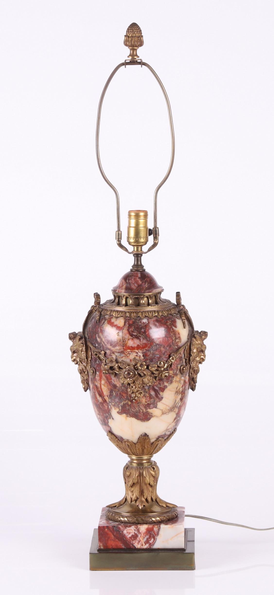 A Ormolu Mounted Marble Lamp: 20th century, with floral, mask and acanthus leaf elements. Dimensions: 10" x 7", 34" tall including the harp. Provenance: From a local estate