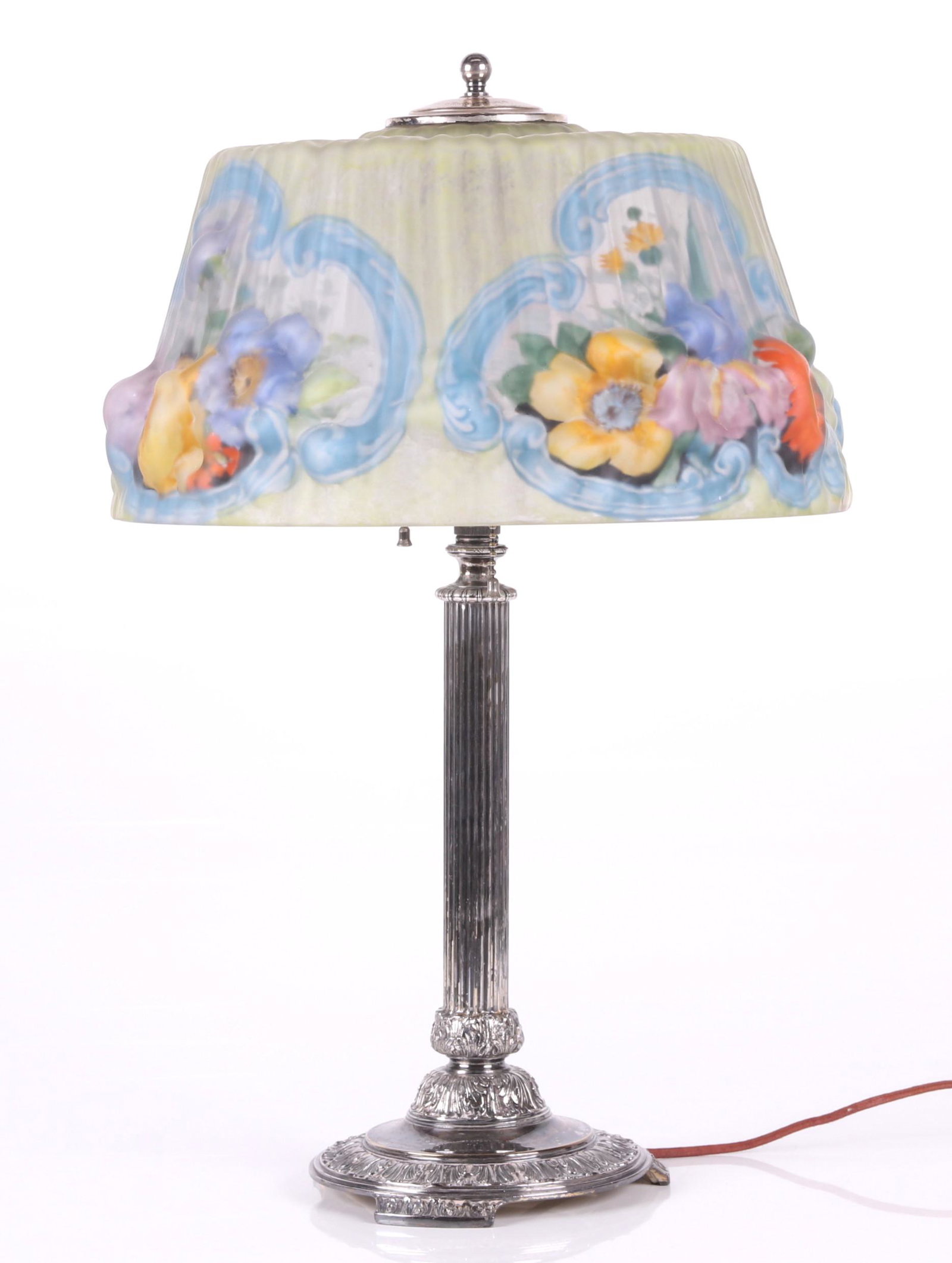 A Pairpoint Puffy Lamp: Early 20th century, with a silver plated column form base and a reverse painted "puffy" molded glass shade. The base is marked E3056. Dimensions: The shade is 14" in diameter, the overall height is 22