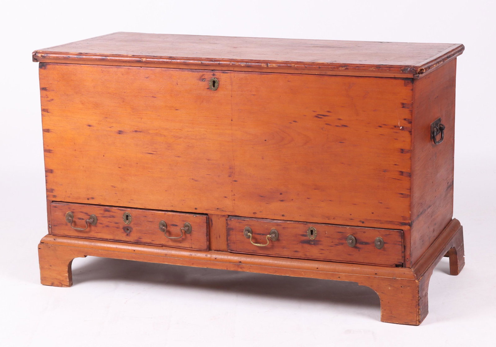 American Pine Dower Chest: Circa 1800. With old replaced bracket foot base, below two short dovetailed drawers; the case is dovetailed, and the lid features breadboard ends and original strap hinges. Dimensions: 44" x 20", 26 1