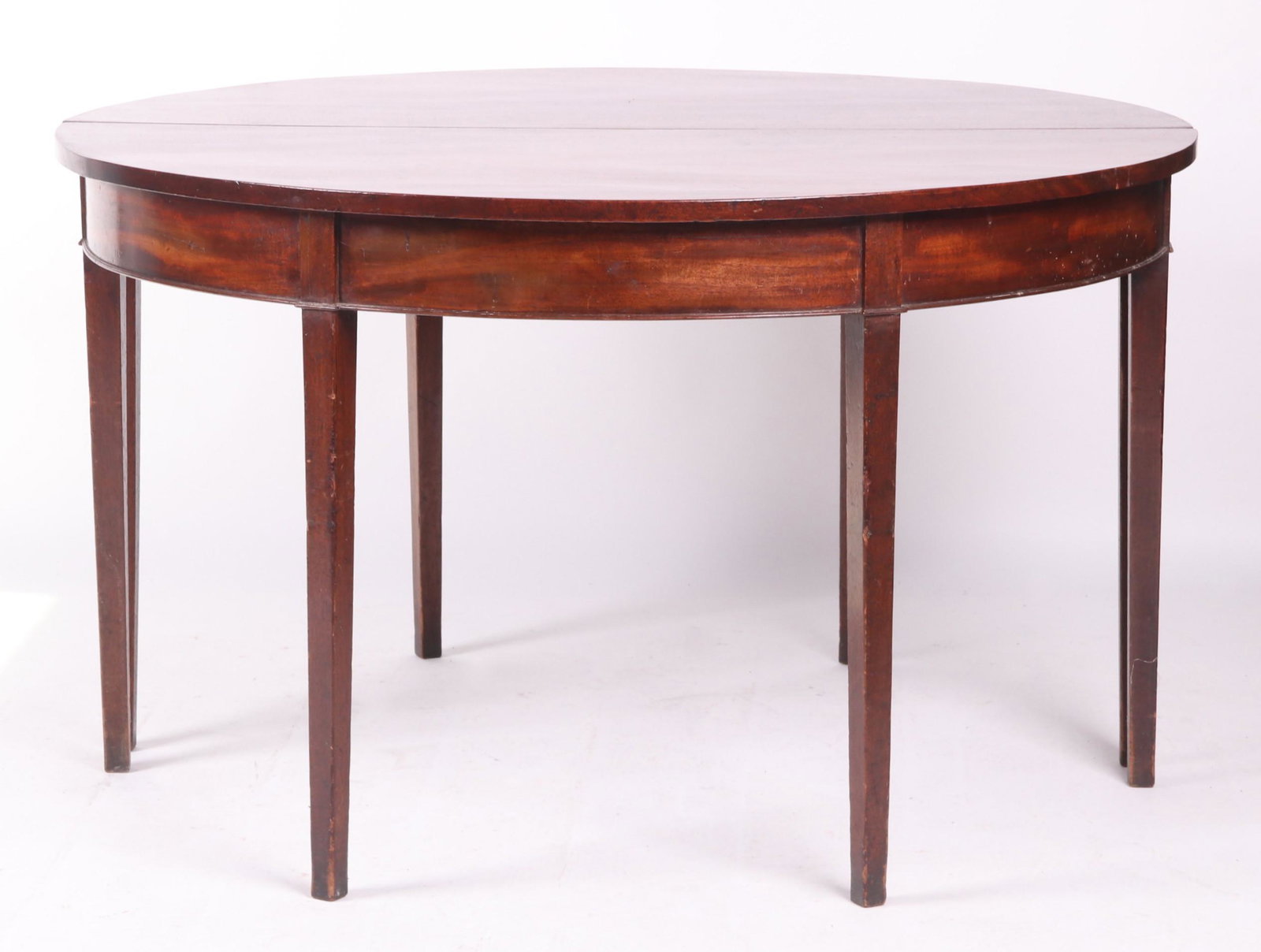 Two Part Hepplewhite Dining Table: Mahogany, with square tapered legs, molded frieze, and D shaped tops that together make a circle. Dimensions: 48" x 47" when together; 28 1/4" in height. Provenance: From a local collection.