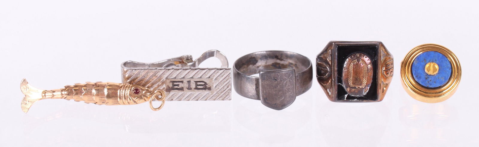 Estate Jewelry, Including a Dunhill Lapel Pin: A Dunhill 10k gold and lapis lazuli lapel pin, a 14k gold articulated fish pendant, a sterling silver tie clip, a 1938 10k gold class ring set with onyx, and a sterling ring with a crest. Dimensions: