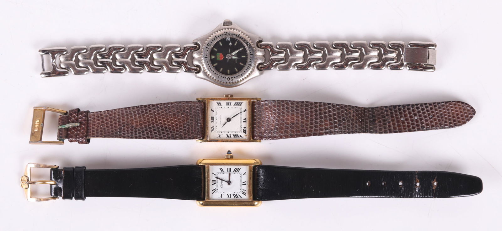 Three Watches Including Cartier: A ladies 18k electroplated tank watch with box, a Juvenia gold plated ladies watch with a movement numbered 765, and a Fake Tag Heuer stainless steel ladies watch with a quartz movement. Dimensions: T