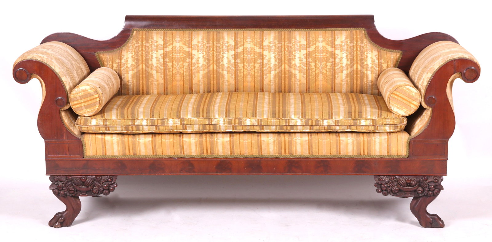 American Classical Mahogany Sofa: Circa 1830. With animal paw feet below cornucopia carved decoration, below a molded frieze, scrolled arms with undecorated roundels, all below the tablet back with scrolled ends. Dimensions: 84" from 
