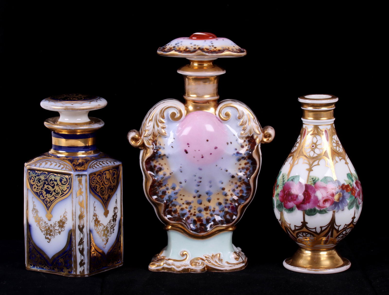Three Old Paris Porcelain Scent or Perfume Bottles: All 19th century, each hand painted and unmarked. Dimensions: From 2 1/2" x 2 1/2" to 4 1/4" x 2", the heights range from 5 1/8" to 7". Provenance: From a Philadelphia estate.