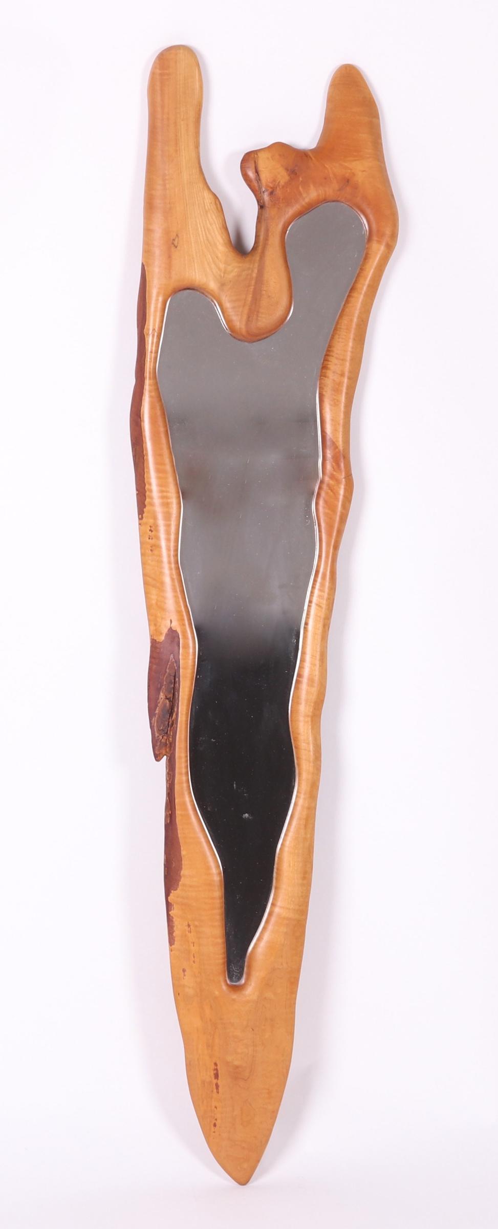 A Large Free Form Modern Mirror: Maple, with some figure to the wood, unsigned. Dimensions: 71" x 17" at the widest.