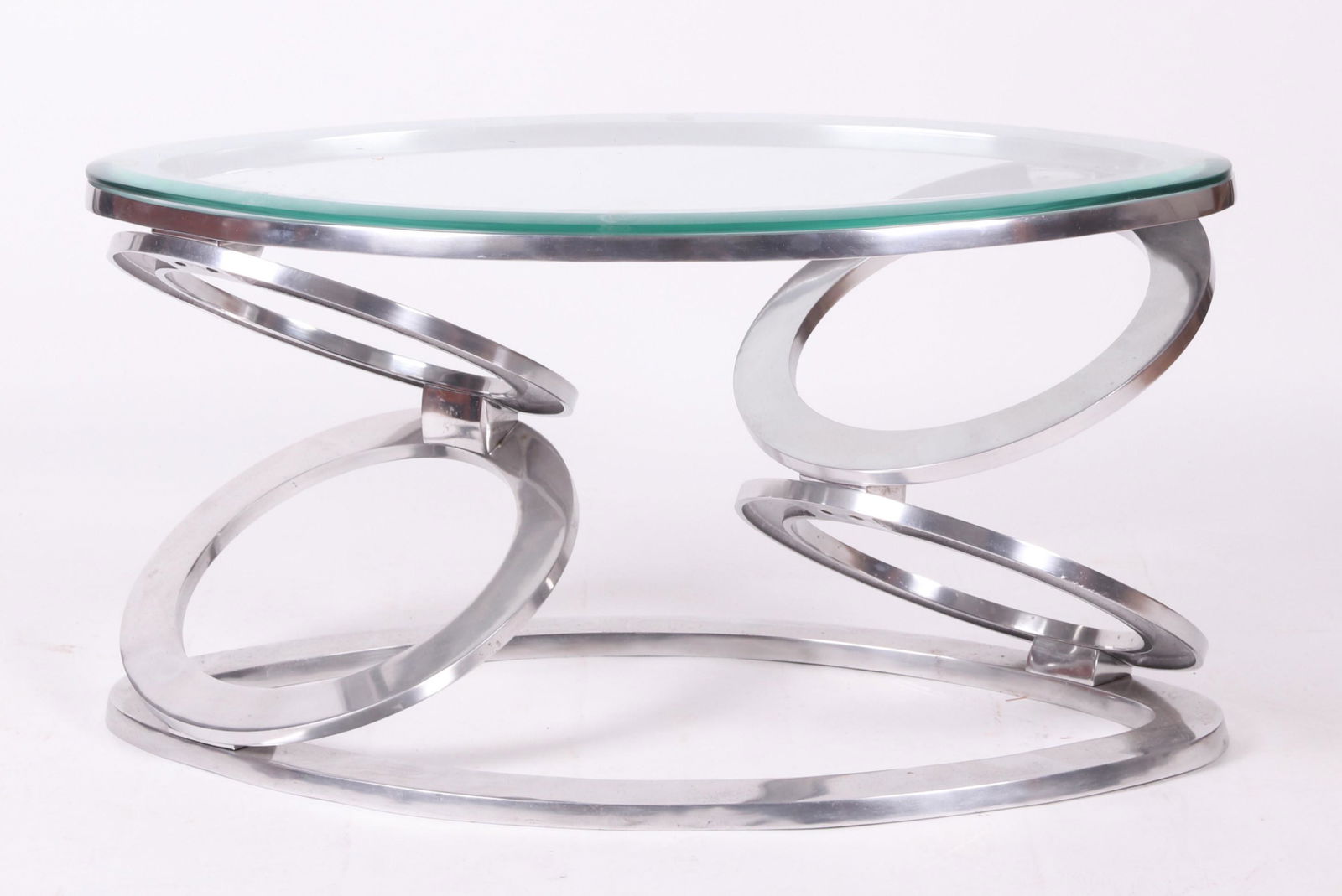 A Chrome and Glass Modern Coffee Table: With an oval base below stacked circular supports, all below the oval top. Dimensions: 36" long, 20" wide, 19" tall.
