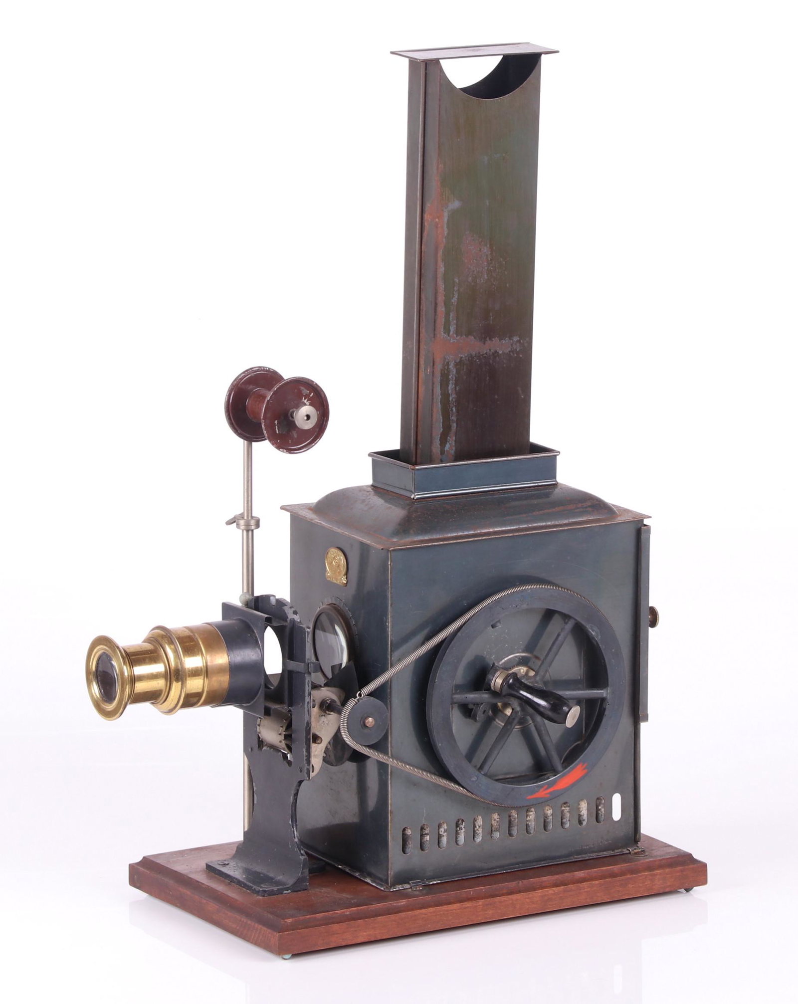 Ernst Plank Cinematograph Film Projector: Kinematador No. 791/792, a late 19th century painted tin oil lantern projector with a hand crank for running celluloid film strips, includes a brass lens and other metal apertures, two film strips, th