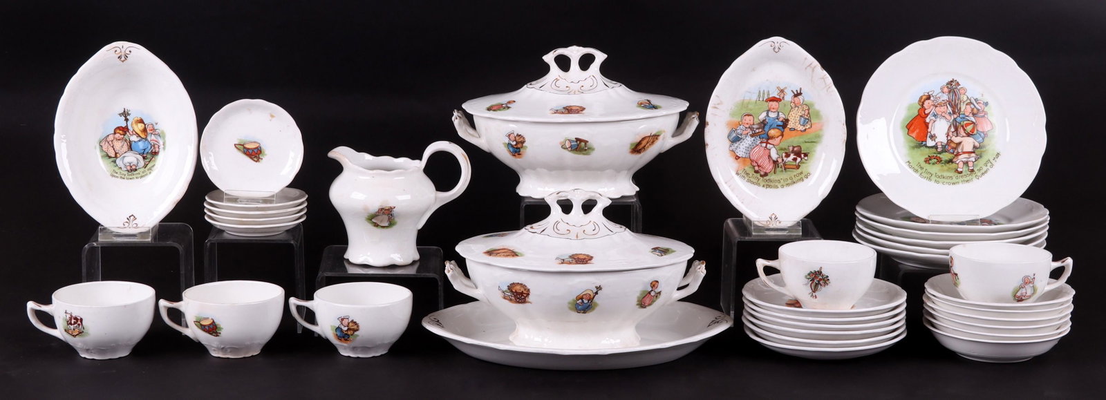 A Set of Transfer Decorated Dinnerware Circa 1910: By Taylor, Smith & Taylor, each piece with colorful transfers depicting children, toys and animals.Some pieces with text that refers to the characters as the "Tiny Todkins". 34 pieces total. Dimension