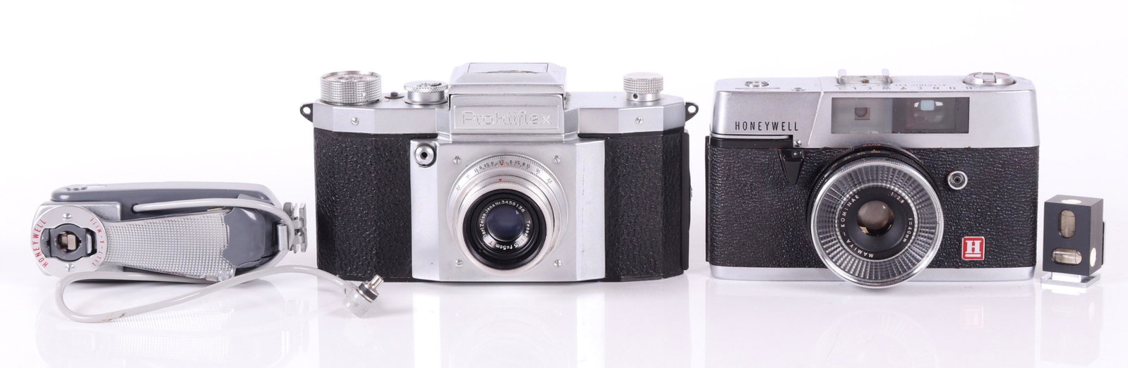 Two Cameras and Accessories: Praktiflex camera with Carl Zeiss Jena lens, 1:3,5, P=5 cm, with brown leather case; Honeywell Electric Eye 35R with Mamiya-Kominar lens, 1:2.8, f=40 mm, with brown leather case; Honeywell Tilt-A-Mite