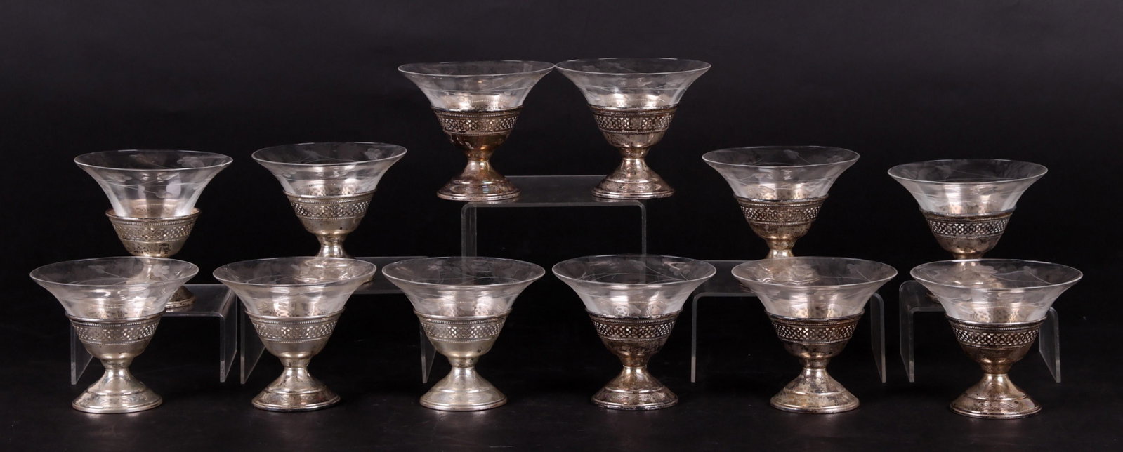 Twelve Sterling Silver and Etched Glass Sherbets: Each with a pierced and beaded stand, and glass insert with etched floral decoration, the stands marked sterling. Dimensions: Each is 4 1/4" in diameter, 3 1/2" in height. The total approximate combin