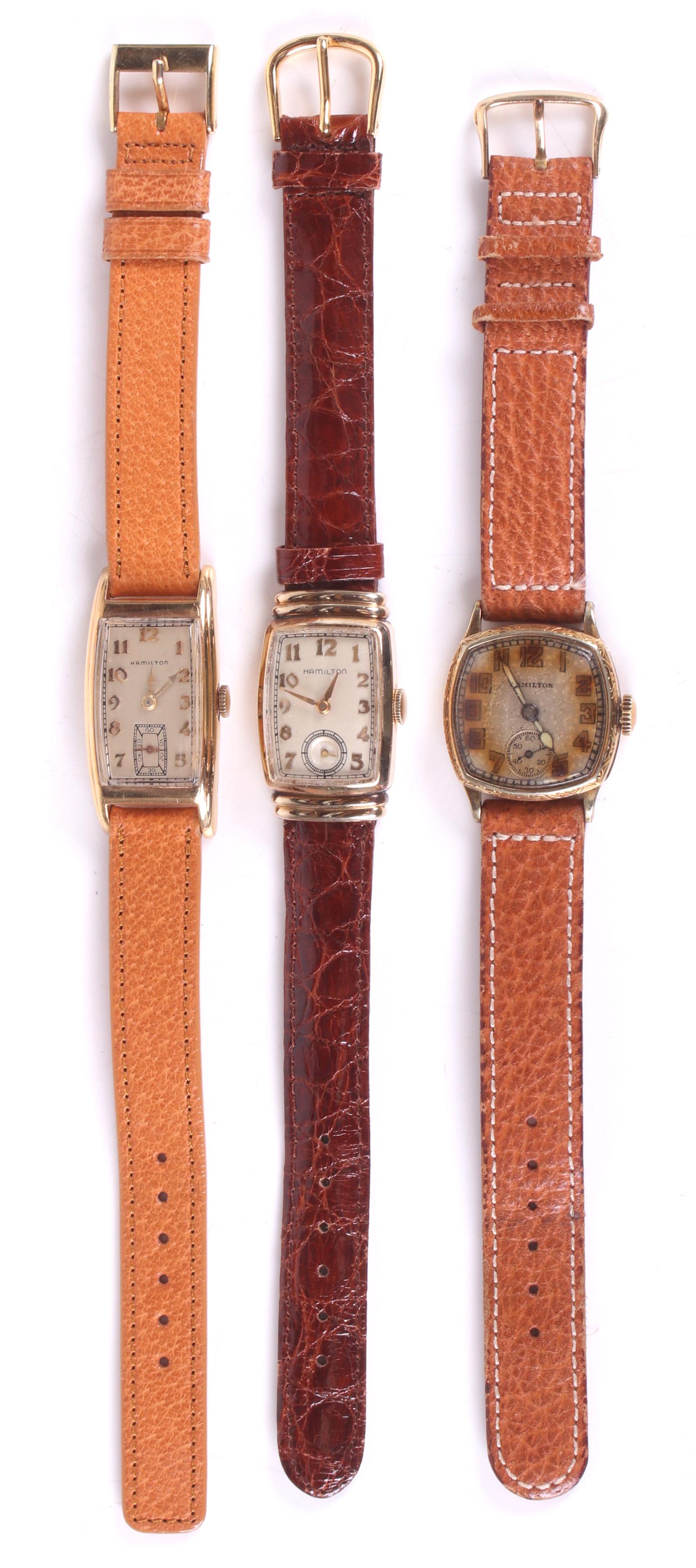 Three Vintage Men's Hamilton Wristwatches: A 14k gold filled example with a rectangular case with a 17 jewel movement, a 14k gold filled square case watch with oversized numerals with a 17 jewel movement, and a rectangular example with a 10k g