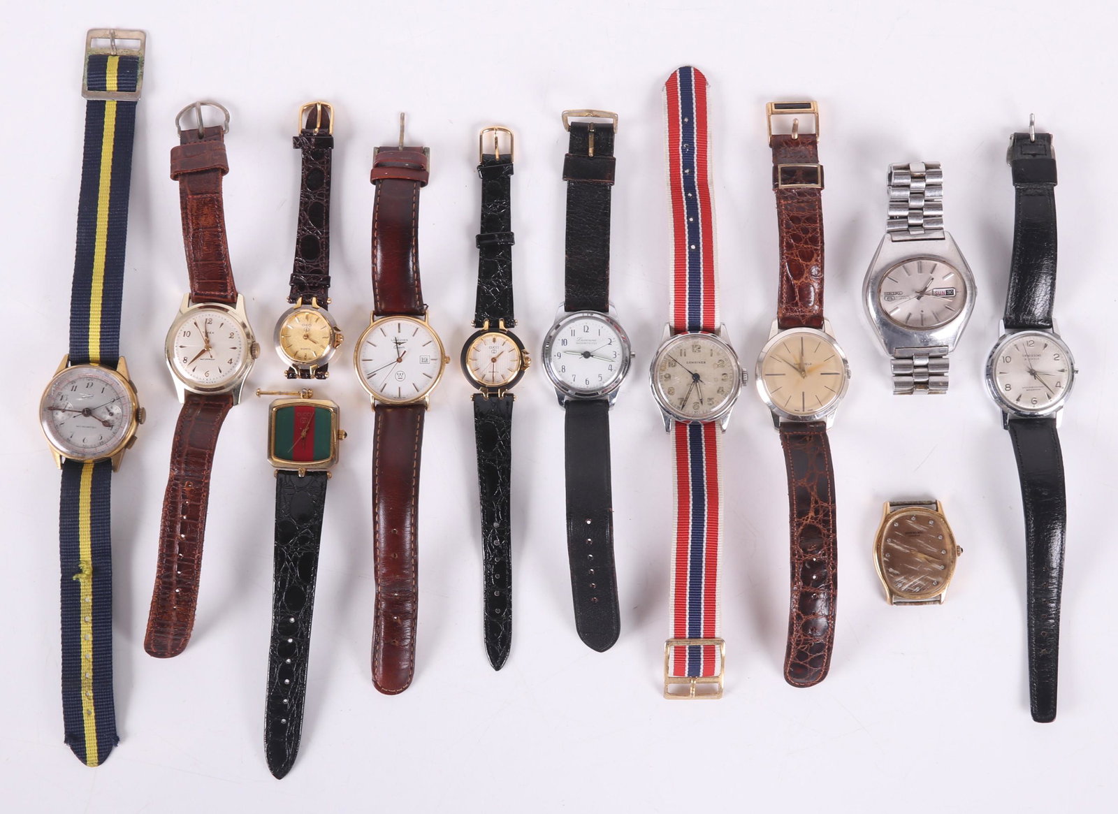 A Group of Estate Wristwatches: The men's examples are by Timex, Sheffield, Lucerne, Niga (a chronograph), Longines (2), S. Kind and Sons, Raymond Weiland, and Seiko. Also in the lot are three fake Gucci ladies watches. Dimensions: 