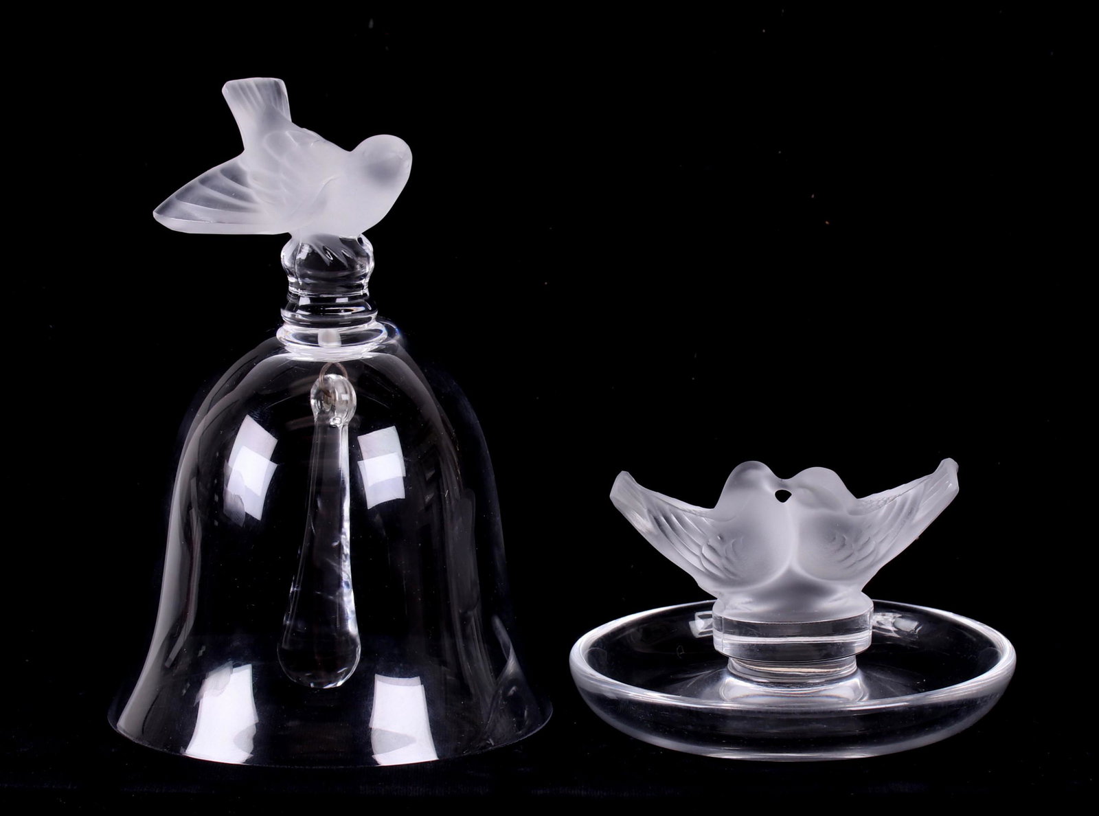 Two Pieces of Lalique Glass: "Nightingale" table bell, and "Colombes" pin tray, each signed, also with original boxes. Dimensions: The bell is 3 3/4" in diameter, 5 1/2" in height; the pin tray is 3 3/4" in diameter, 2 1/4" in he