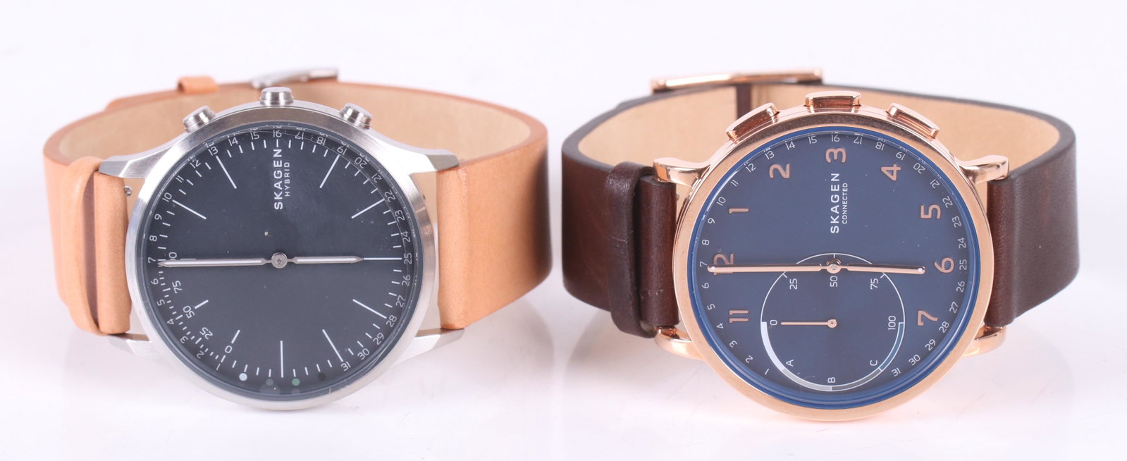 Two Skagen Men's Smart Watches: Modern, Skagen "Connected" and "Hybrid", with original cases and paperwork. Dimensions: Each box is 3 1/2" x 3 1/2" x 3 1/2".