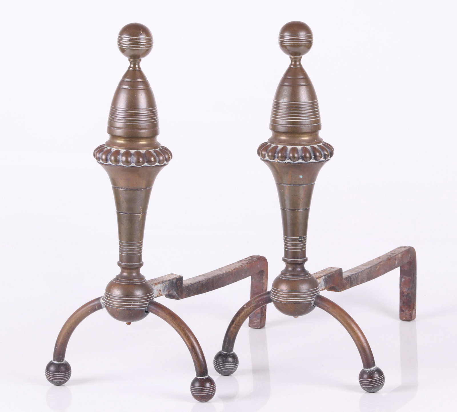 A Pair of Brass Aesthetic Movement Andirons: From the second half of the 19th century, each with ball feet, a lobed ring and a ball finial. Dimensions: Each is 10" x 17" and 19" tall.