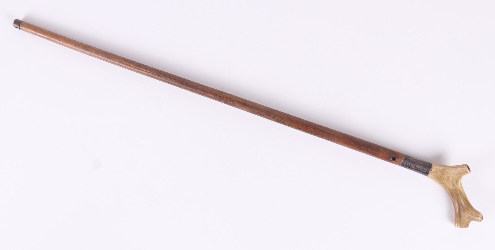 An Antler Walking Stick: With a silver cuff that bears the engraved text "Edmund Foster 1800". Dimensions: 37" long. Provenance: From a local collection.