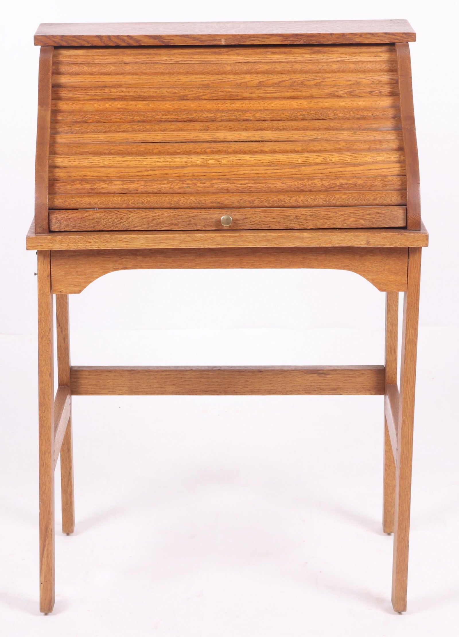 A Child Size Oak Roll Top Desk: 20th century, with square legs and a serpentine roll top that opens to reveal a writing surface and cubby holes. Dimensions: 22" x 16", 32" tall. Provenance: From a Philadelphia collection.