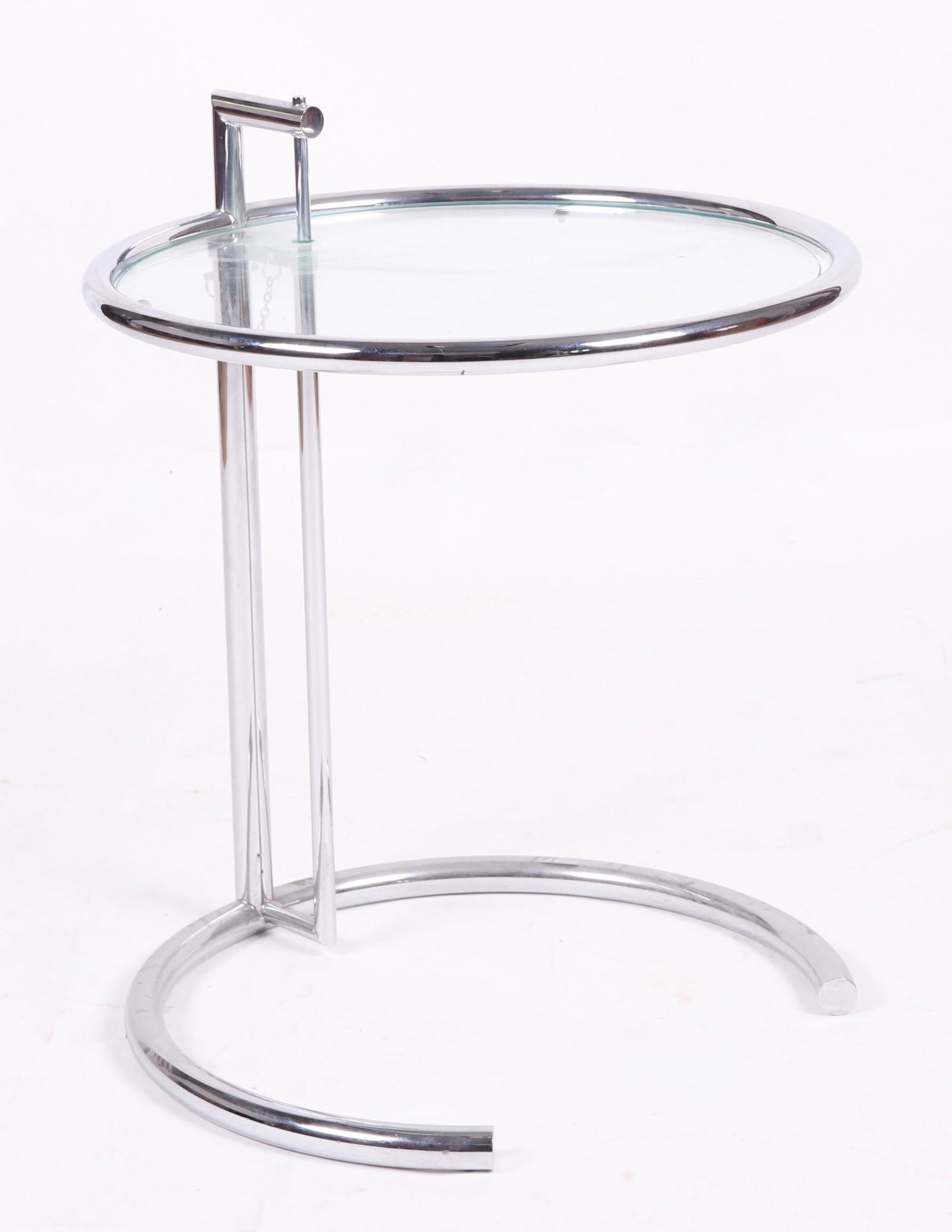 A Table Designed by Eileen Gray: 20th century, chrome and glass, the height is adjustable. Unknown maker and exact age. Dimensions: 19 3/4" in diameter, the height adjusts from 21 1/2" to 32 1/2".