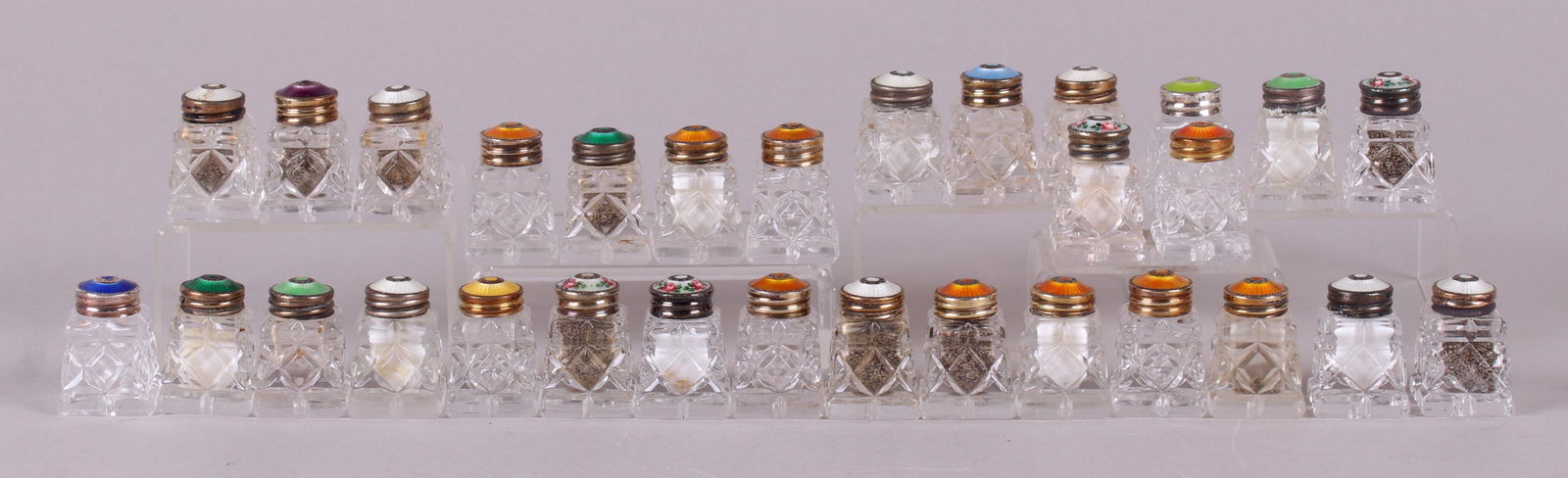 David Andersen, Norway Enamel Silver Shakers: 15 pairs, each with a sterling and enamel cap, various colors, some floral decorated. Dimensions: Each is 1 3/8" x 1 3/8" and 1 3/4" tall. Provenance: From a local collection.