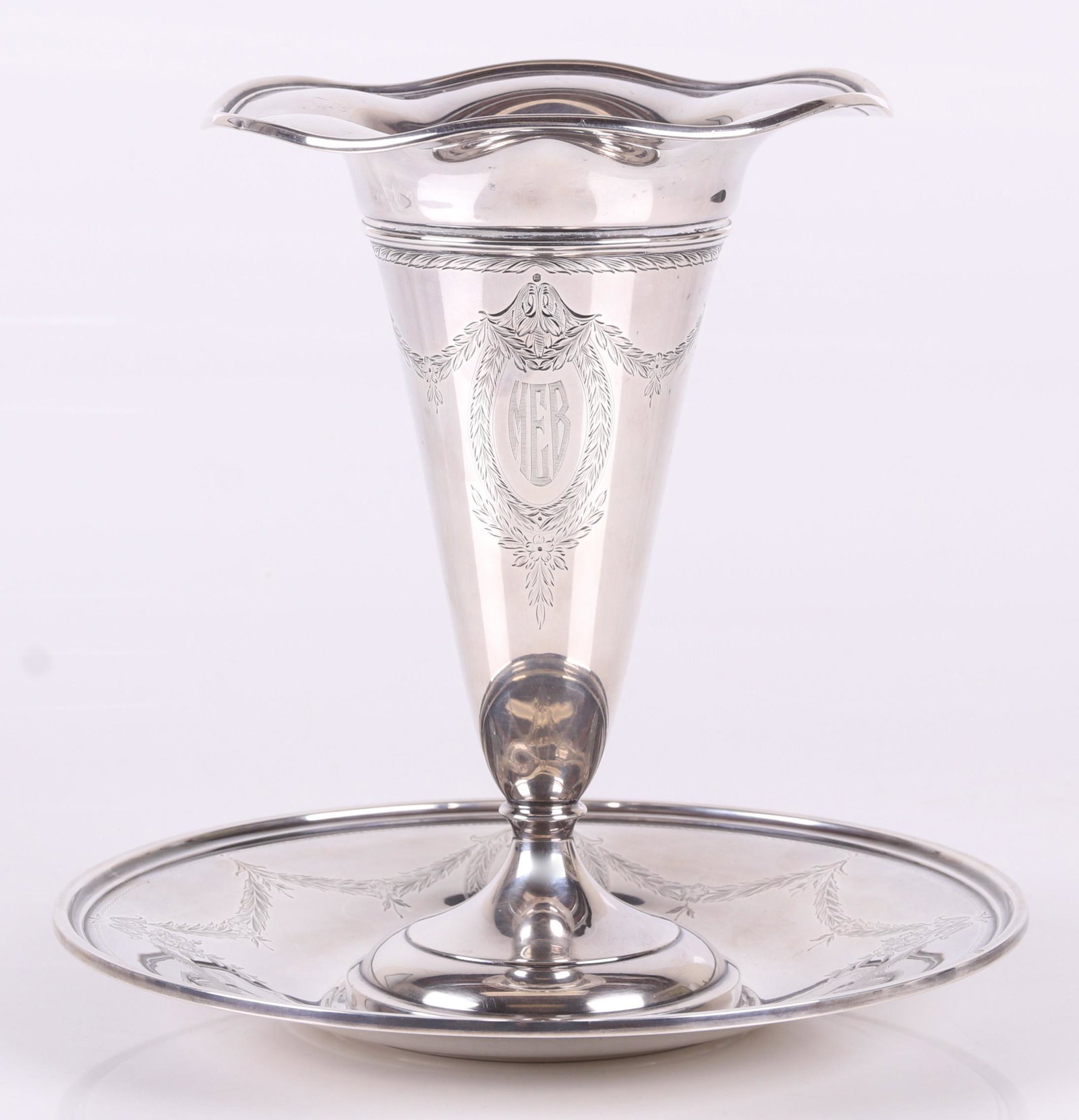A Sterling Silver Trumpet Vase with Stand: American, early 20th century, the vase with a circular molded foot, engraved swags and a ruffled top edge, the associated stand (not original) with similar engraving. Dimensions: The vase has a diamet