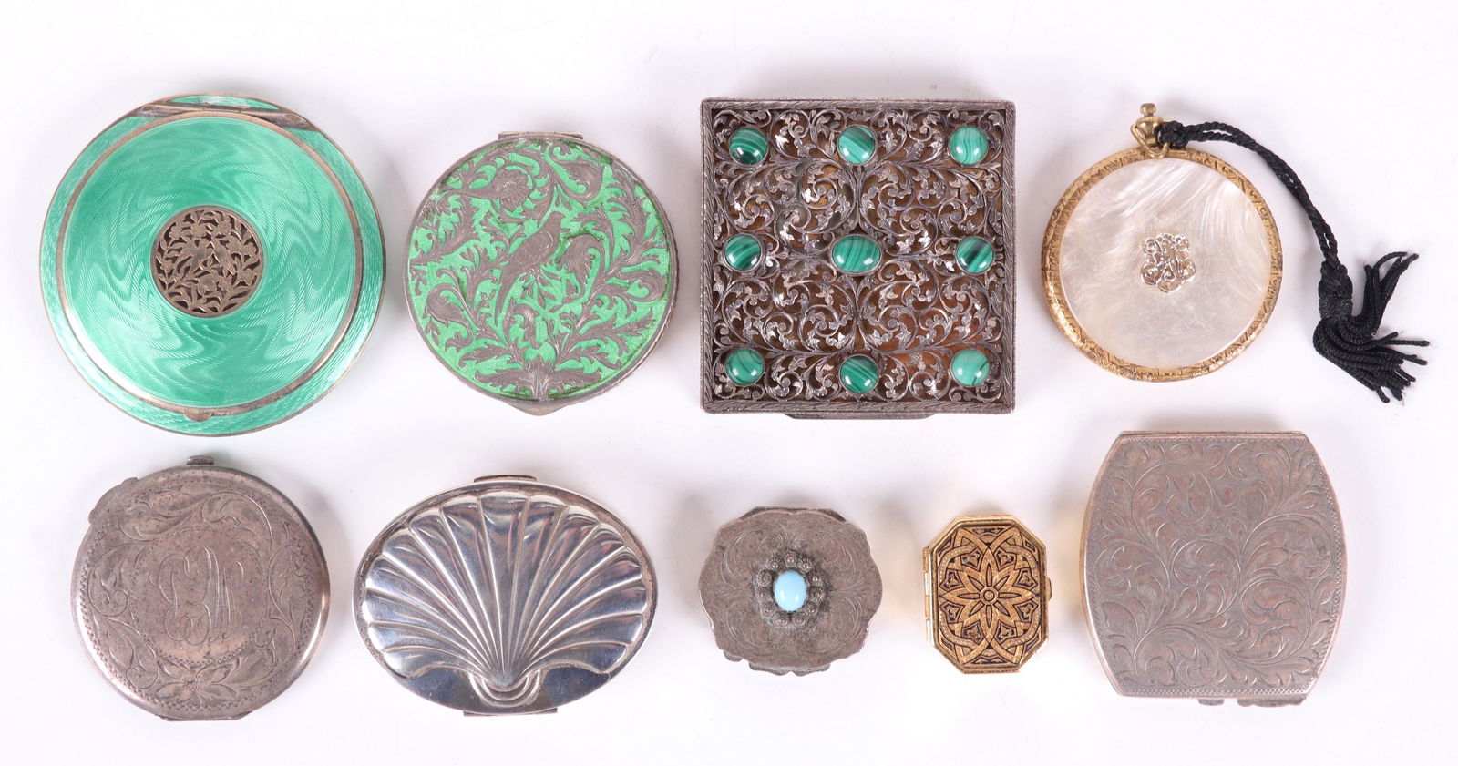 A Group of Silver Compacts, Etc...: Comprising: an 800 silver and malachite example with a scrolled openwork lid, an 800 silver Italian pill box with central glass "jewel", two Birks sterling compacts with engraved decoration, two 935 A