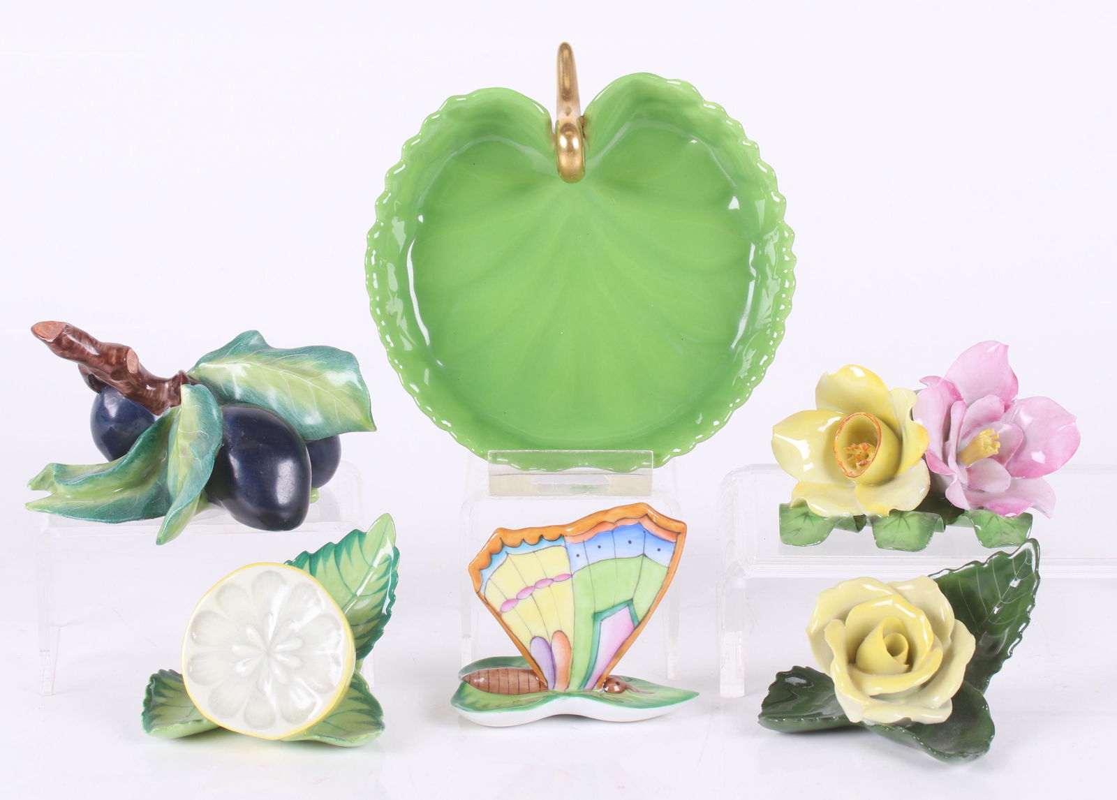 Herend Porcelain Place Card Holders: Five place card holders in the form of fruit, flowers , a butterfly and a small lilypad form tray. Dimensions: From 2 1/2" x 1 3/4" to 4" x 4", the heights range from 1/2" to 2 1/2". Provenance: From