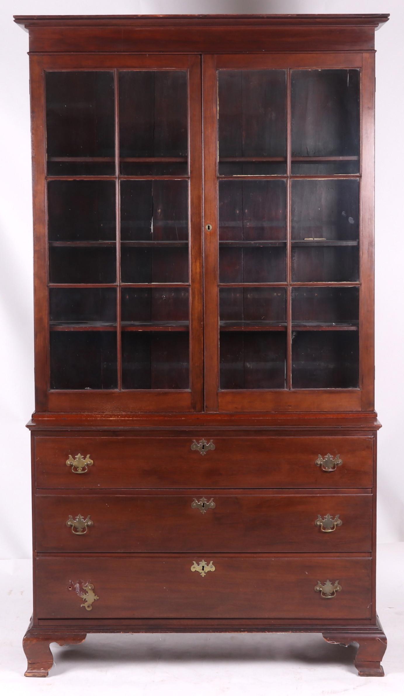 A 19th Century Mahogany Secretary: A two part secretary, the lower case with ogee bracket feet below two dovetailed drawers and an upper drawer with a hinged face for use as a writing surface (not an original feature) , the upper case 