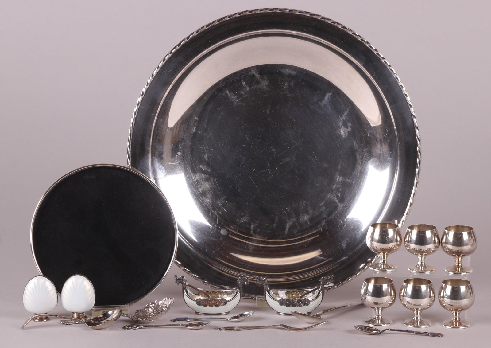 A Group of Sterling and Enamel Items: Comprising: a set of six Gorham cordials with matching sterling rimmed tray, a circular tray by Towle, a pair of Viking boat form open salts with matching spoons marked for Norway, a pair of sterling 