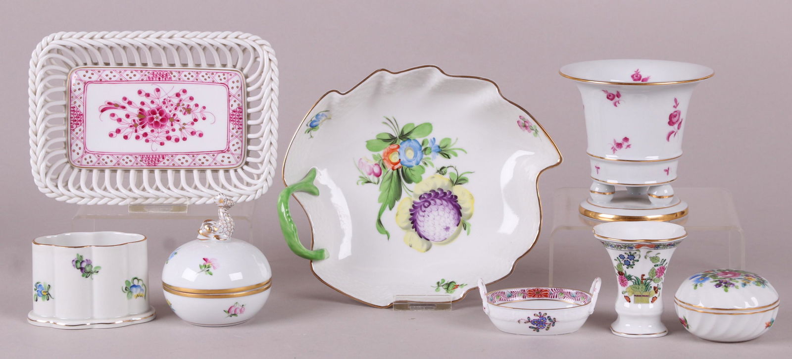 An Assortment of Herend Porcelain: Comprising: a toothpick holder in the Indian Basket Multicolor pattern, a small vase with circular base and three ball feet, a leaf form dish with floral decoration and having an early mark, an open s