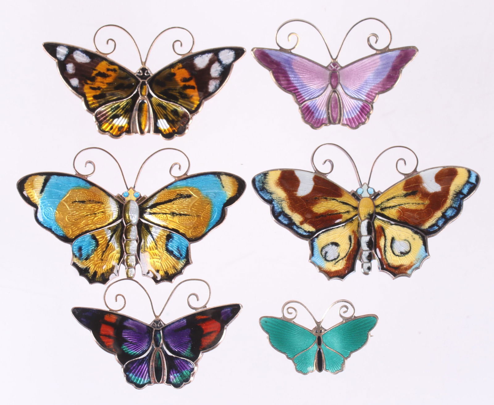 A Group of Sterling Pins, David Andersen, Norway: Six butterfly pins, all sterling with enamel, various colors. Dimensions:From 1 1/8" x 3/4" to 2 3/8" x 1 1/2". The total approximate gross weight is 1.8 troy ounces. Provenance:From a local collectio