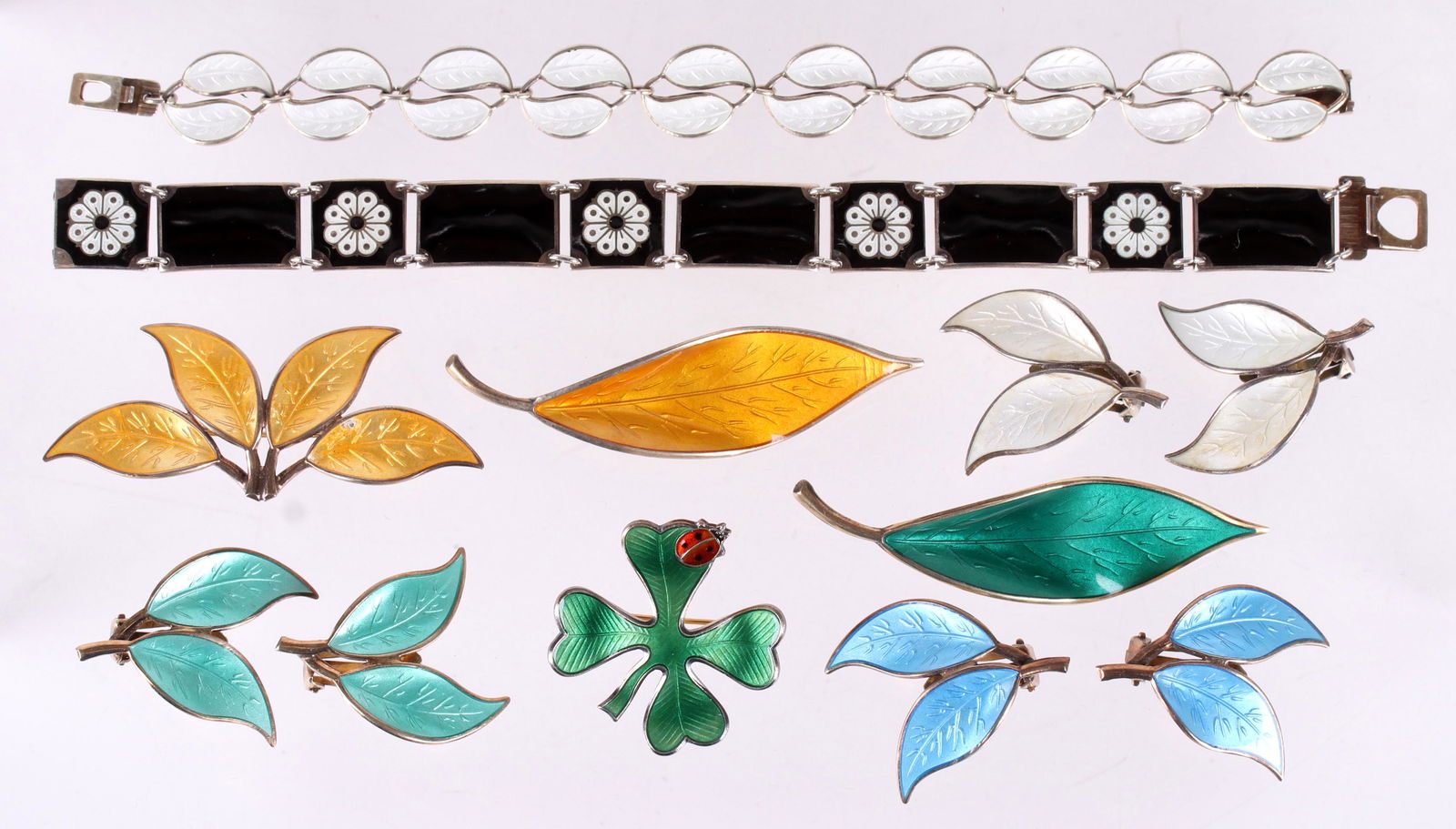 David Andersen Sterling Jewelry, Pins, Etc...: All sterling with enameling, two bracelets, one with white leaf form links, the other black with white flowers, three foliate pins, a clover pin with ladybug decoration, and three pairs of foliate ear