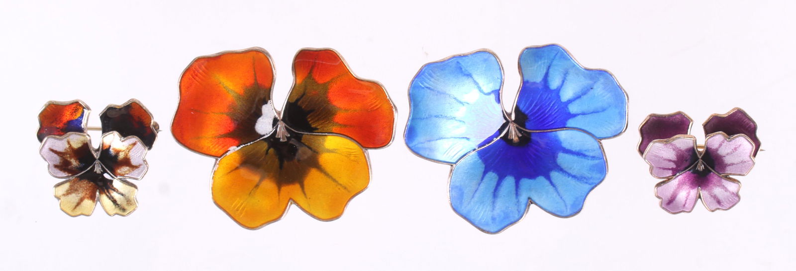 Four Sterling, Enamel Pins, David Andersen, Norway: All similar in form, in two sizes and colors as pictured. Each marked for the maker and sterling. Dimensions:1" x 3/4" and 1 5/8" x 1 3/8". The total approximate weight is 1 troy ounce. Provenance:Fro