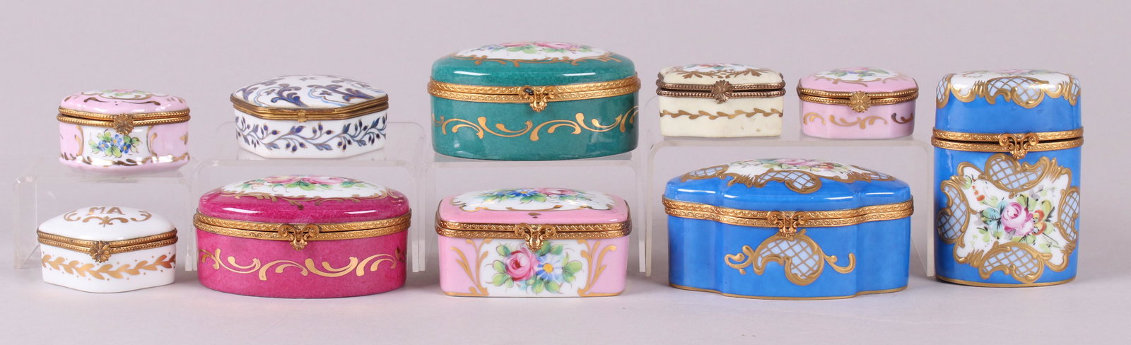 Ten French Porcelain Boxes Including Limoges: All 20th century, various sizes and decoration, all hand painted. Eight examples are marked for Limoges, one was made for Tiffany and Co. Dimensions:From 2 1/2" x 1 3/4" to 4 1/2" x 3", the heights ra