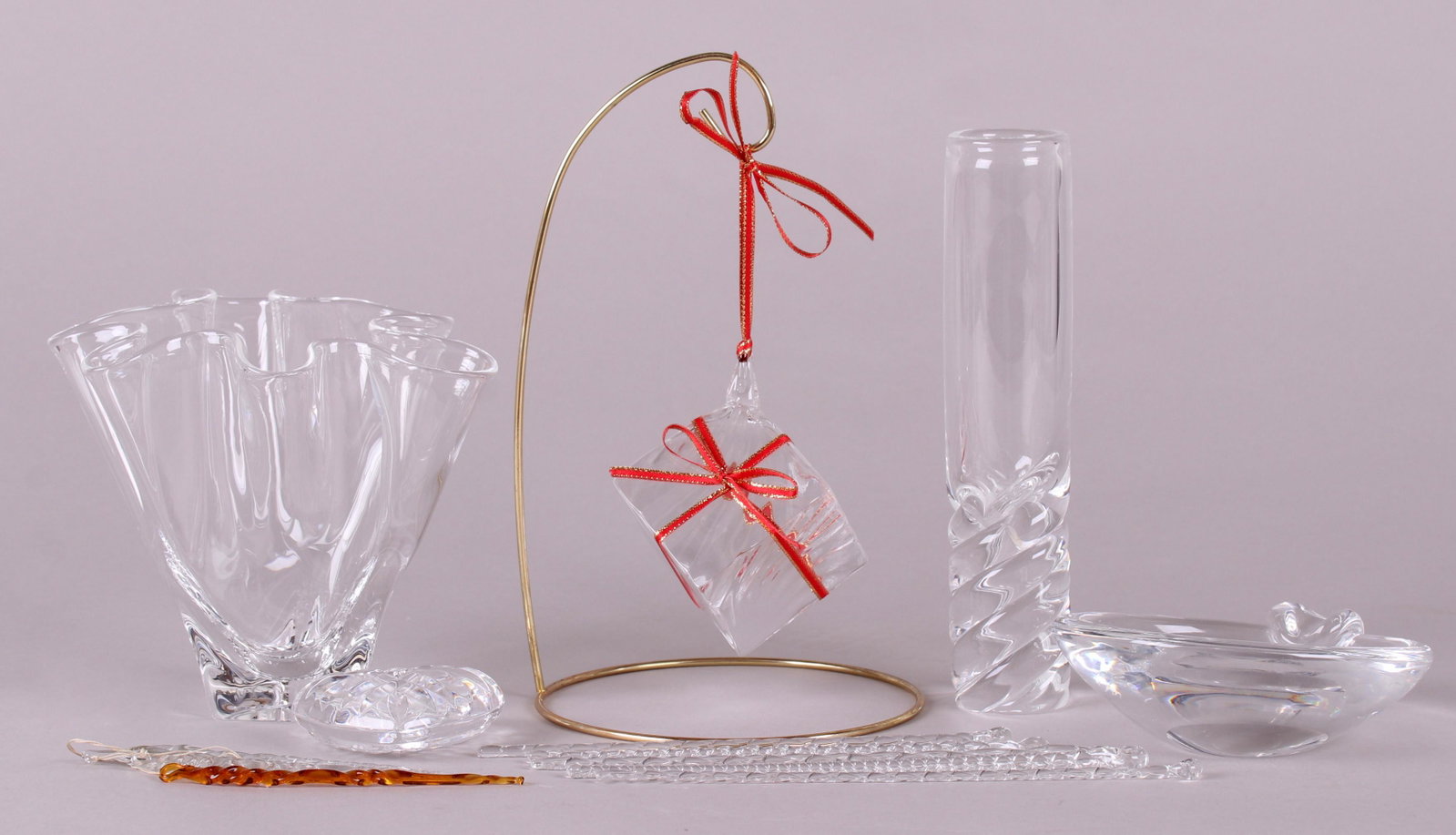 A Group of Estate Glass, Steuben: Comprising: a Steuben handkerchief vase, a Steuben bud vase with a twist base, a Steuben bowl with a single applied handle, a blown glass hanging present ornament with brass stand, a hear form cut gla