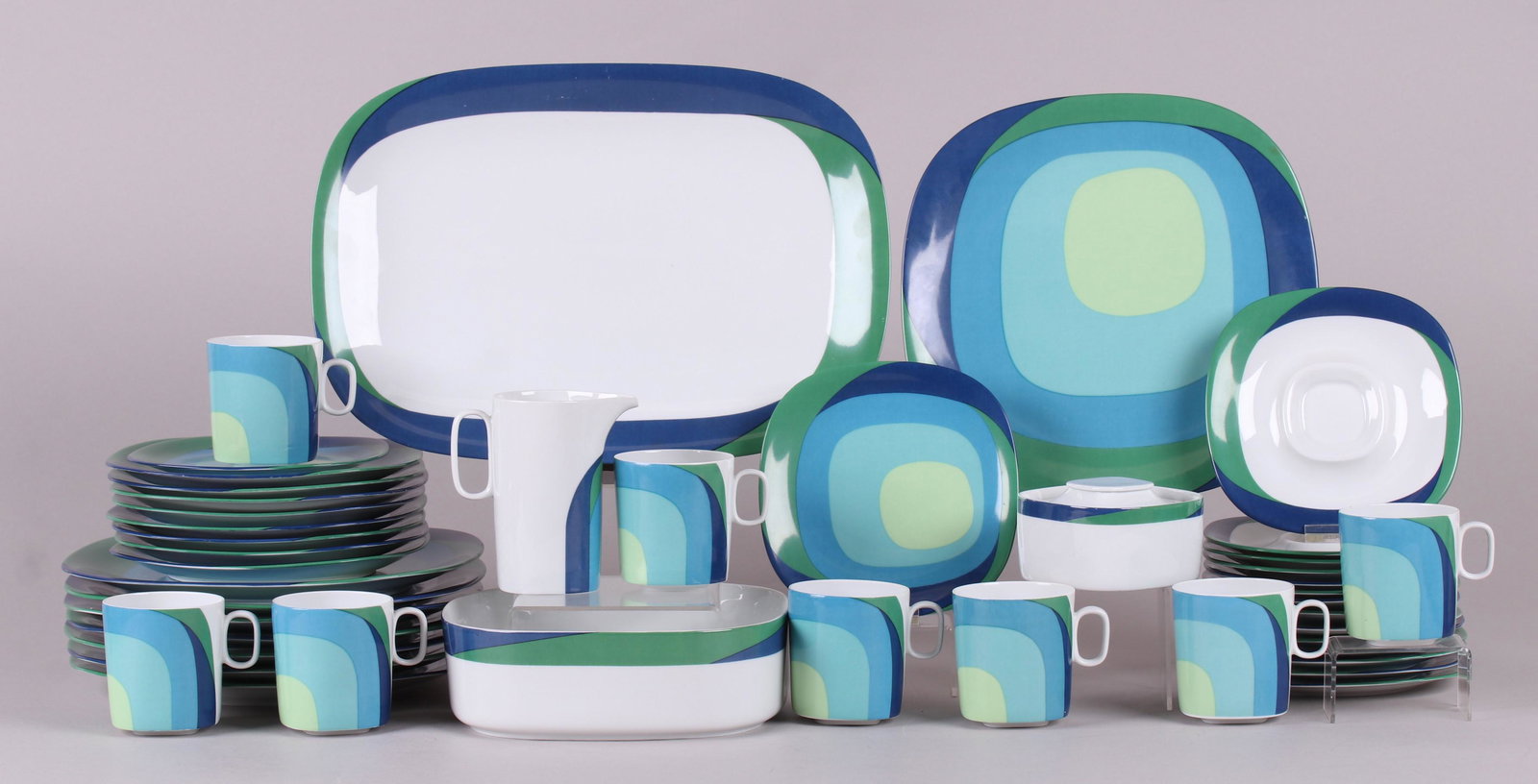 A Set of Mid Century Modern Dinnerware: Block Langenthal, Switzerland, comprising: eight 10" plates, a 4 1/2" creamer, eight 6 1/4" bread plates, eight 3" tall cups with eight matching 6" saucers, a 14" x 10" platter, eight 7 1/2" plates, a