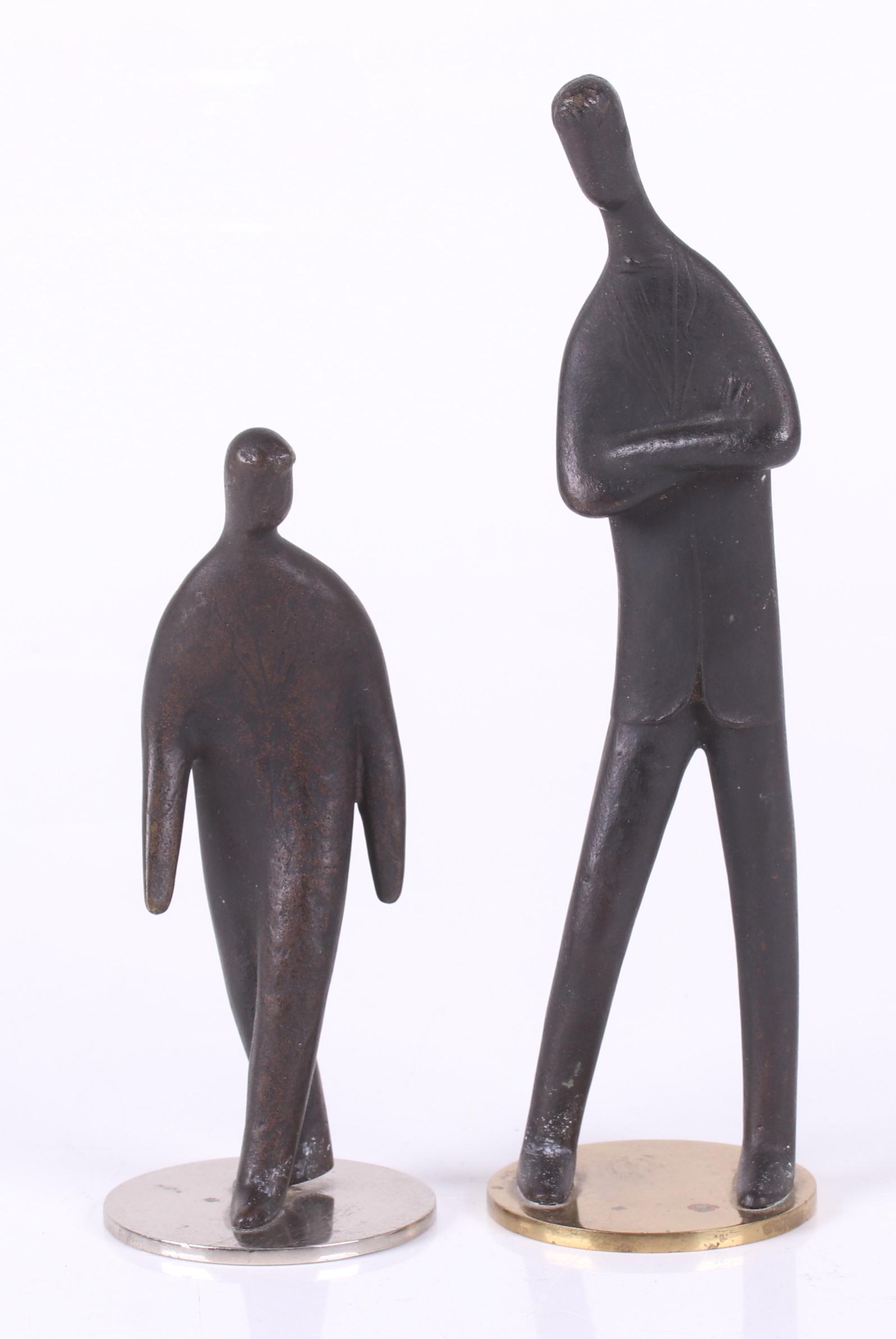 Vienna Bronze Figures, Carl Aubock II (1900-1957): Two patinated bronze figures of men wearing suits, each on a circular base and signed as pictured. Dimensions:Each base is 2" in diameter, the heights are 5" and 7 1/4". Provenance:From a Philadelphia