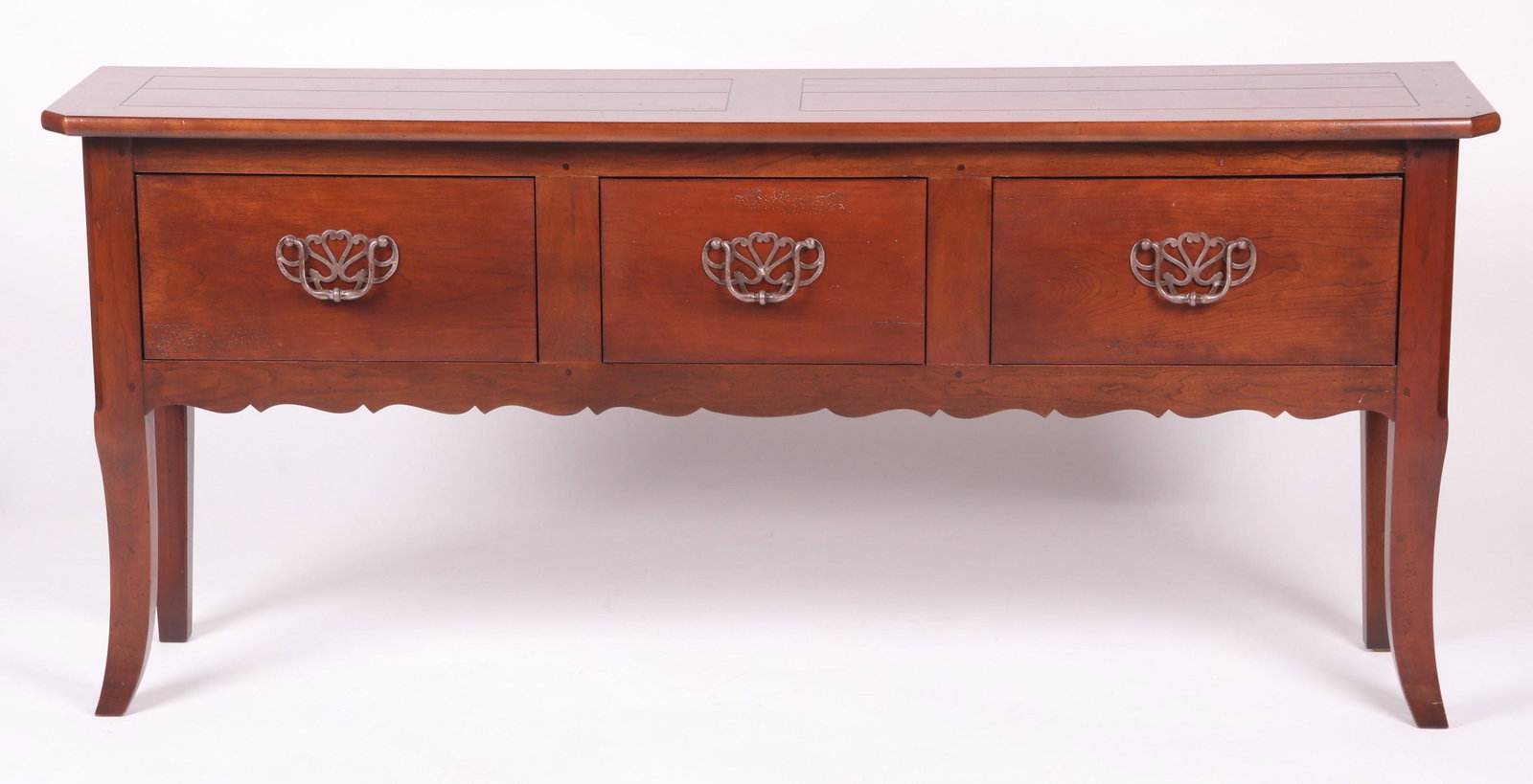A Cherry Hunt Board by Henredon: With outsweeping legs, three large drawers that feature bail pulls. All below a conforming rectangular top. Dimensions:15" x 69". Height is 30" Provenance:From a local collection.