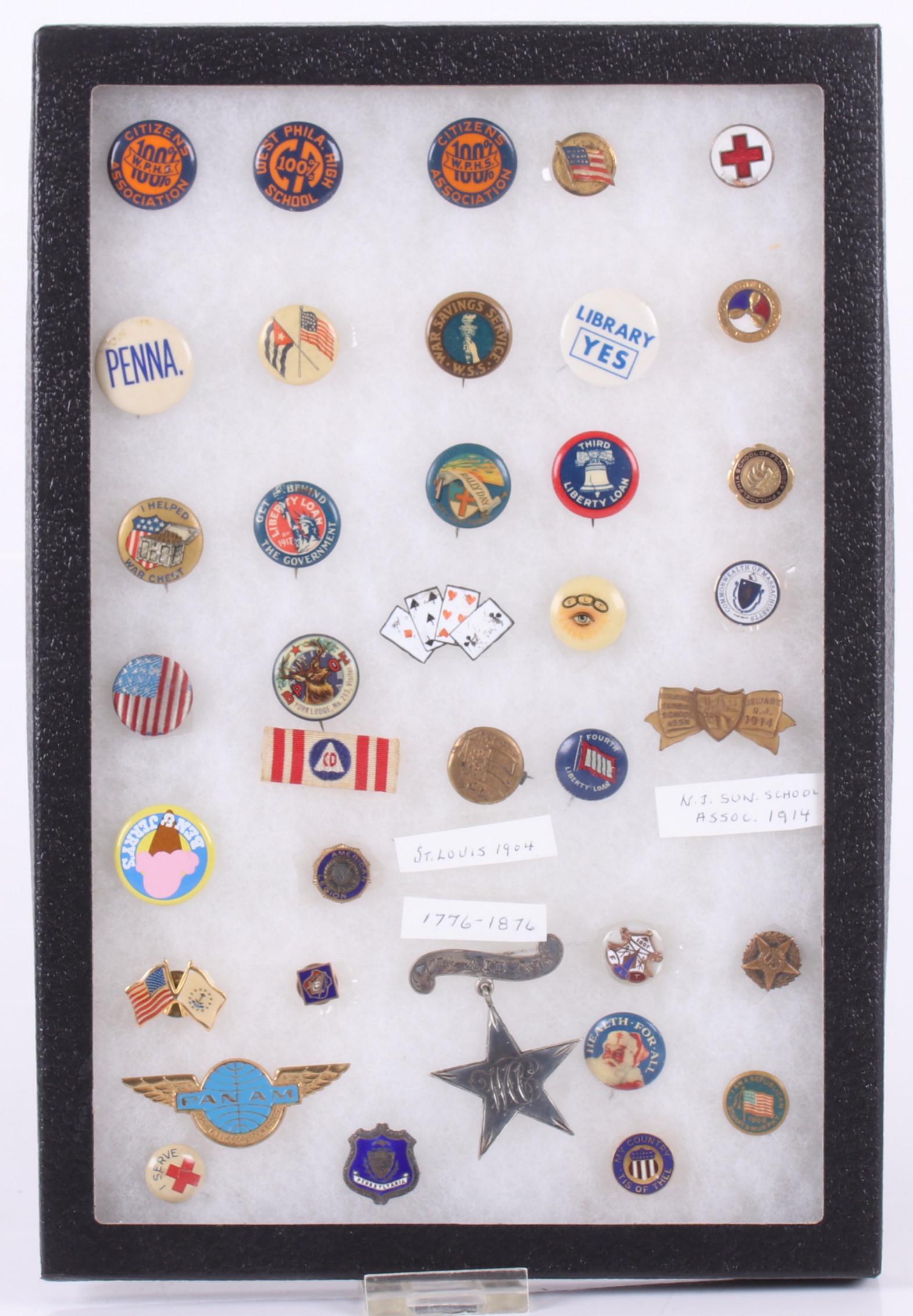 A Group of Collectable Buttons: Mostly from the first half of the 20th century, a variety of subjects including the Centennial, World War II, the American Legion, etc... Dimensions:From 1/4" x 1/4" to 2" x 1 1/2". Provenance:From a 
