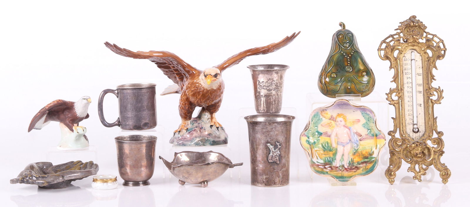 Estate Lot, Including Silver Items: Comprising: a small Crown Staffordshire porcelain eagle, a larger porcelain eagle by Beswick, a Capodimonte tray, a brass tray in the form of hands, a small porcelain open salt, a pear form figural po