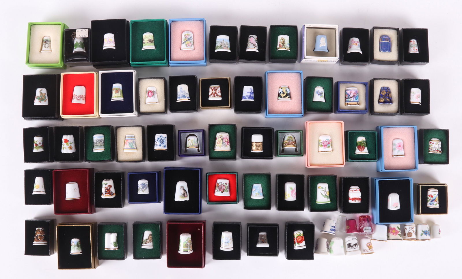 A Collection of Porcelain Thimbles: Seventy examples, all 20th century, makers include: Davenport, Yamase, Walkure, Hutschenreuther, Lindner, Wedgwood, Sutherland, Spode, Rockingham, Whieldon Ware, Longton, Kyouei, Westbury Studio, Chel