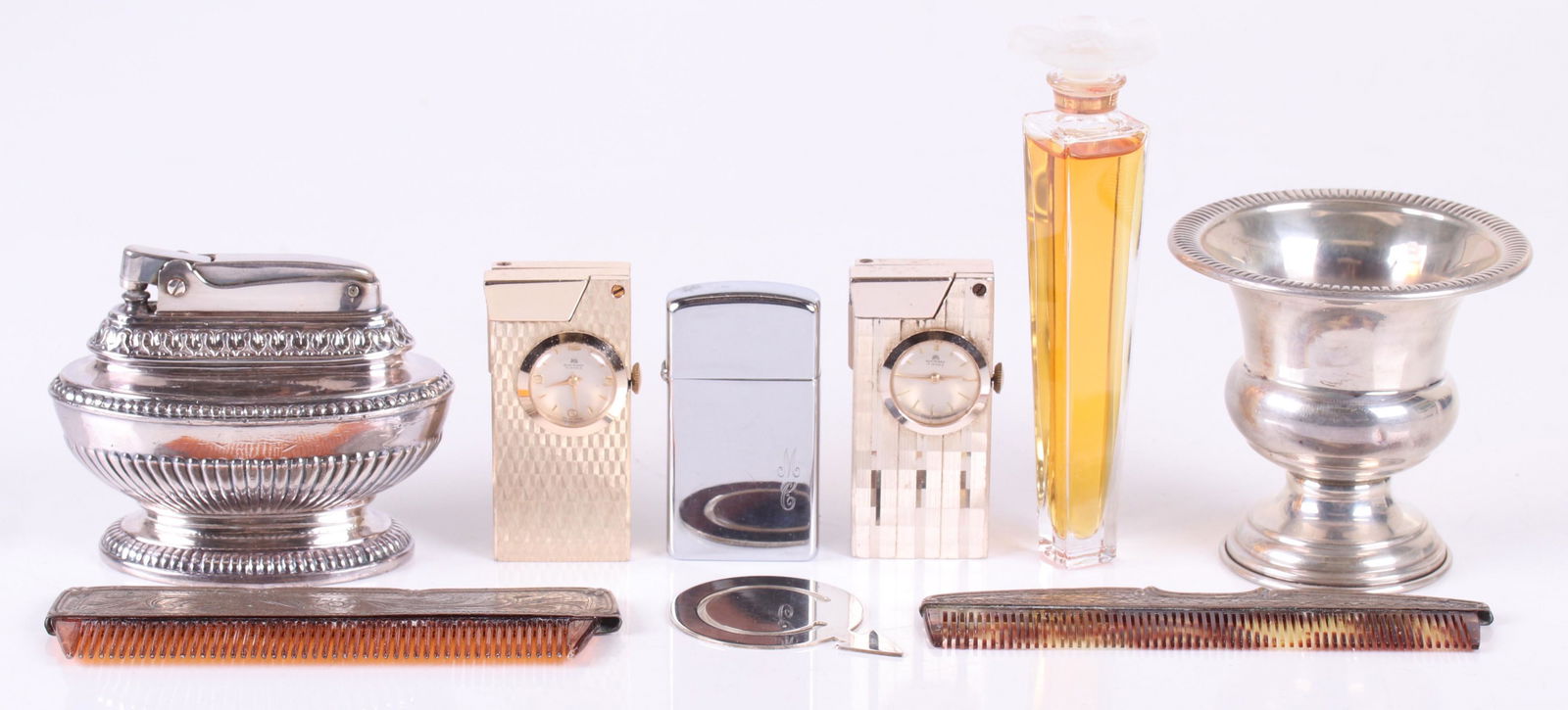 Estate Lot, Including Sterling Items: Comprising: a sterling urn form cigarette holder, a silver tone lighter/watch by Bucherer, a similar gold tone lighter by the same maker, two sterling mounted combs, a Ronson silver tone "Queen Anne"
