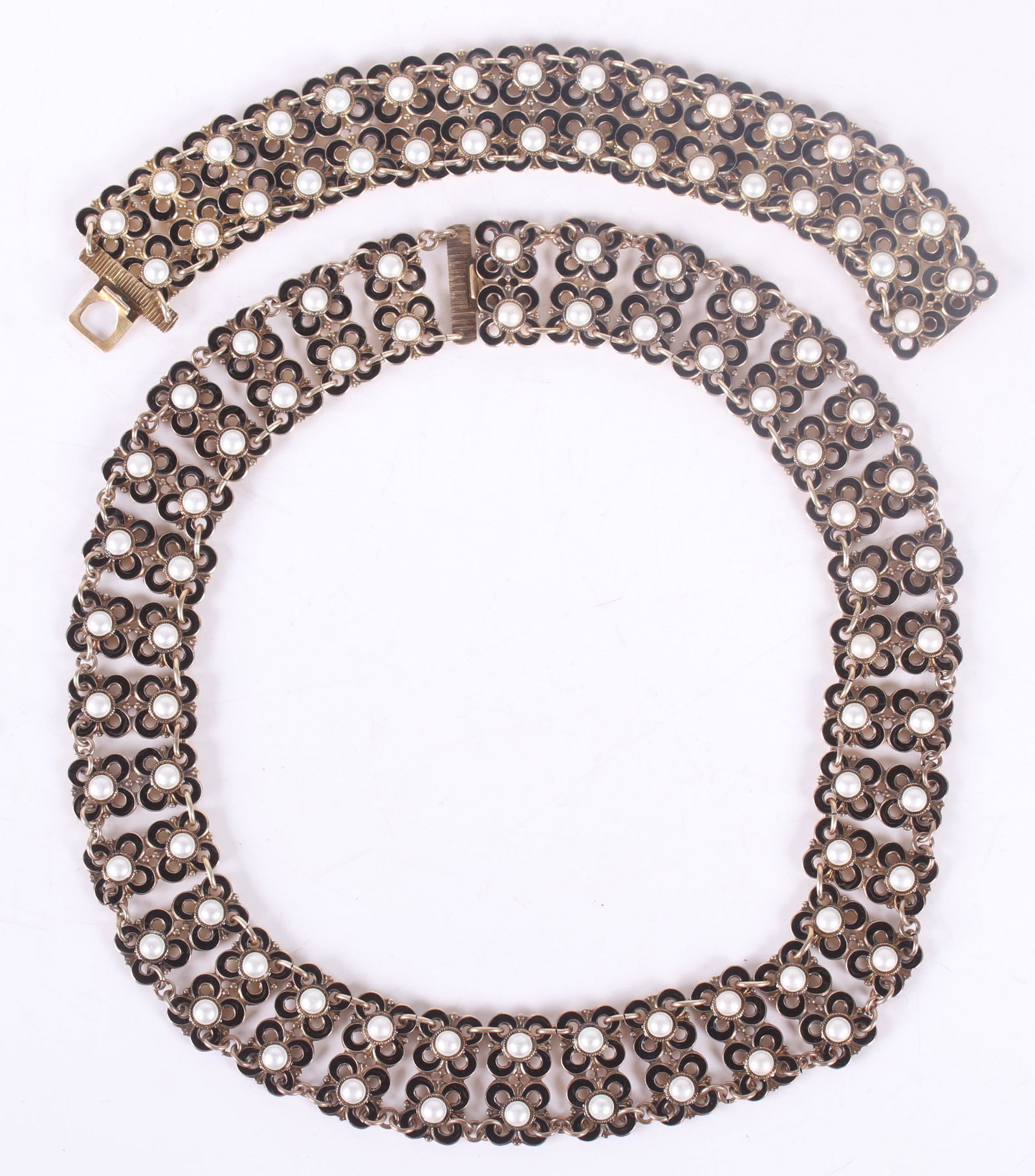 A Matching Bracelet and Necklace, David Andersen: Both sterling and enamel and with black and white floral links. Both signed. Dimensions:The bracelet is 7" x 1" and the necklace is 16" x 1". The total approximate weight is 3 troy ounces. Provenance: