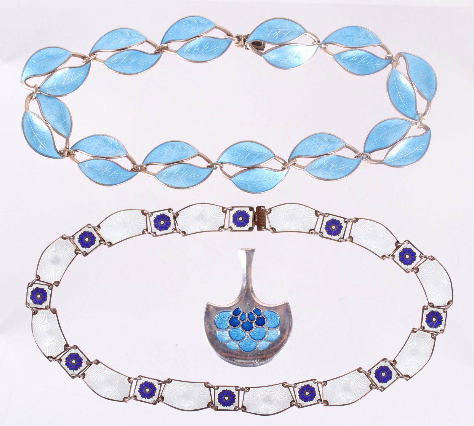 Two Sterling Necklaces and a Pendant, Andersen: Two necklaces and a pendant, all sterling silver with enamel by David Andersen. One necklace features blue enameled foliate links, the other has white and blue enamel with floral decoration and the pe